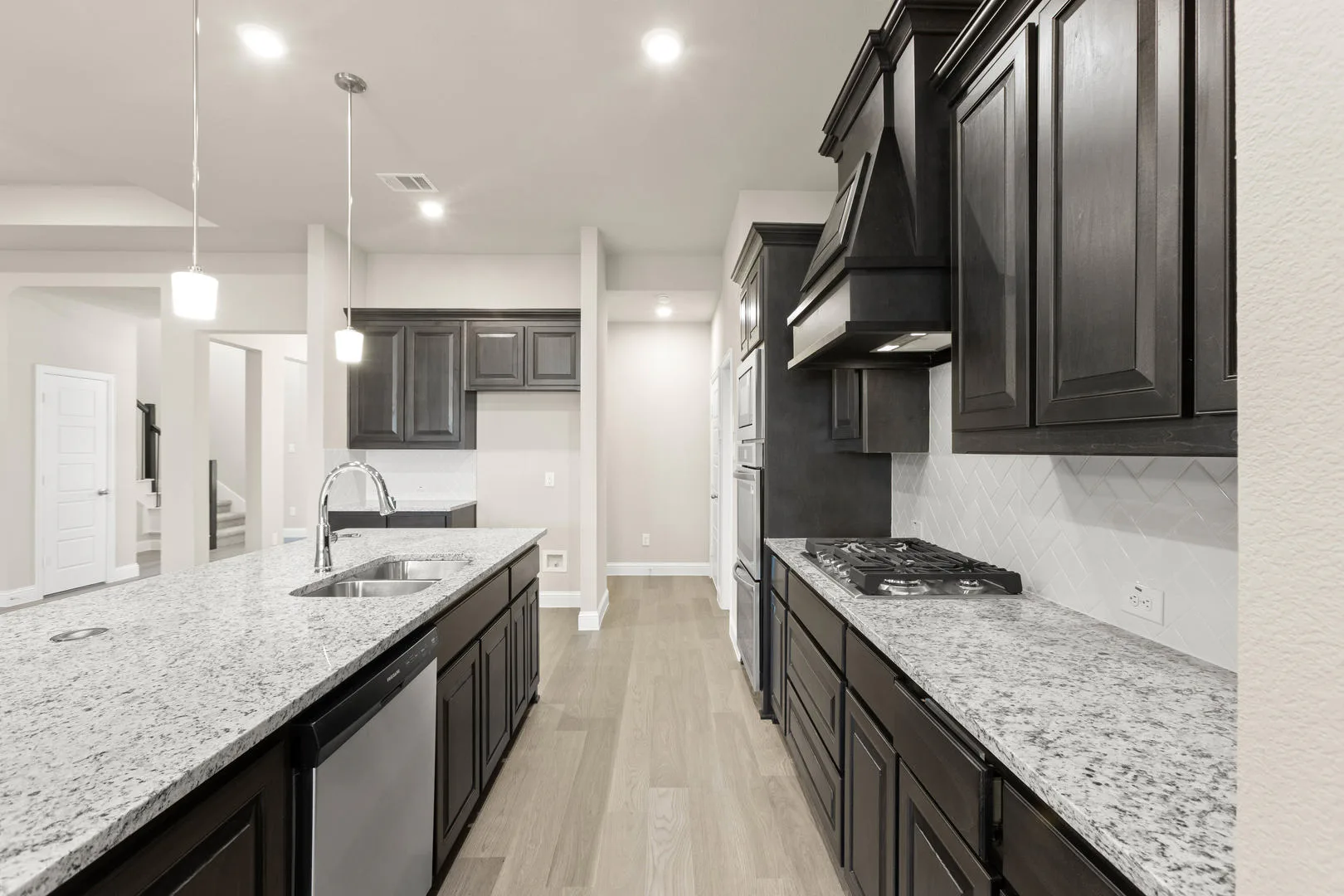 Kitchen in a new traditional style home by Kindred Homes