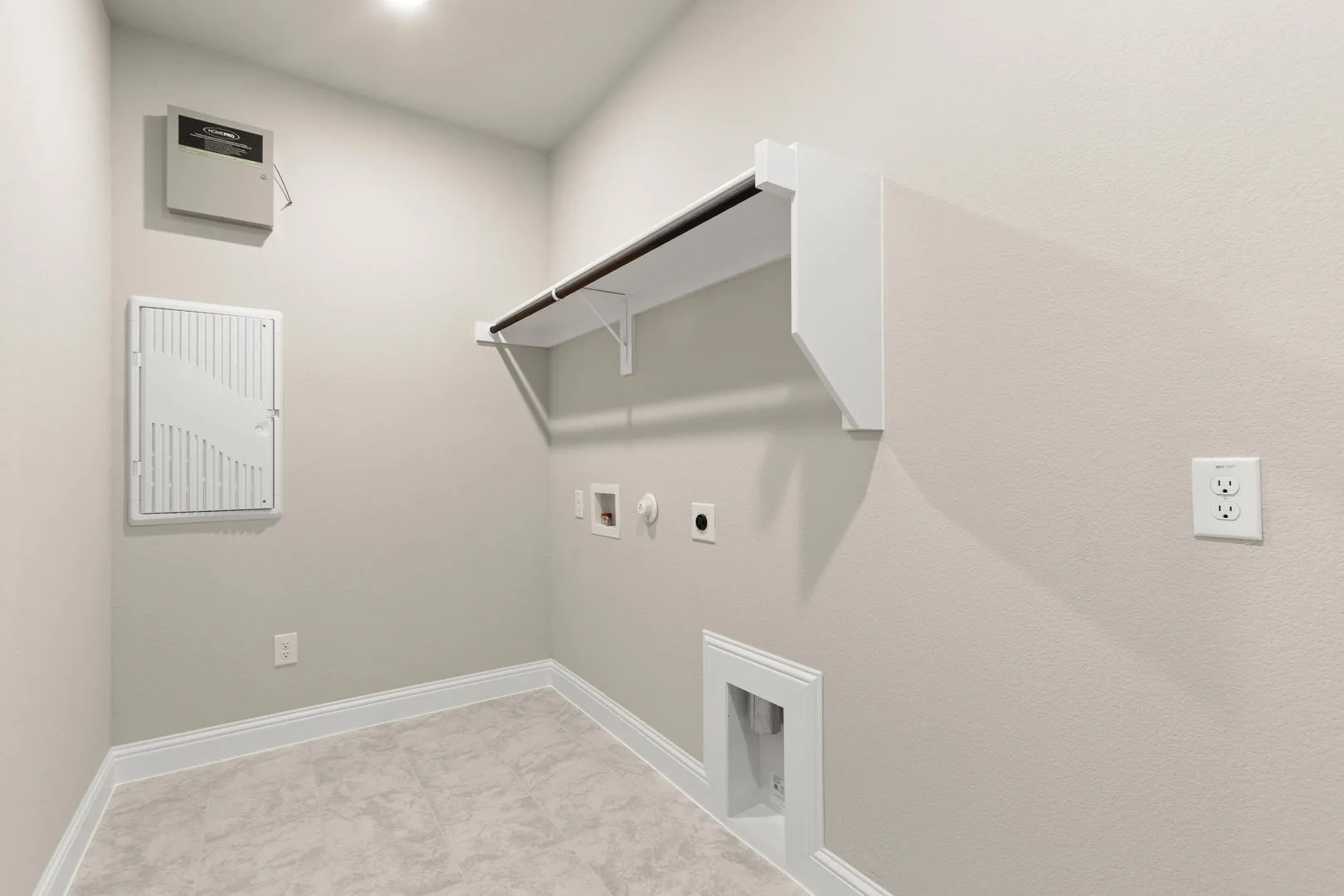 Utility room in a new traditional style home by Kindred Homes