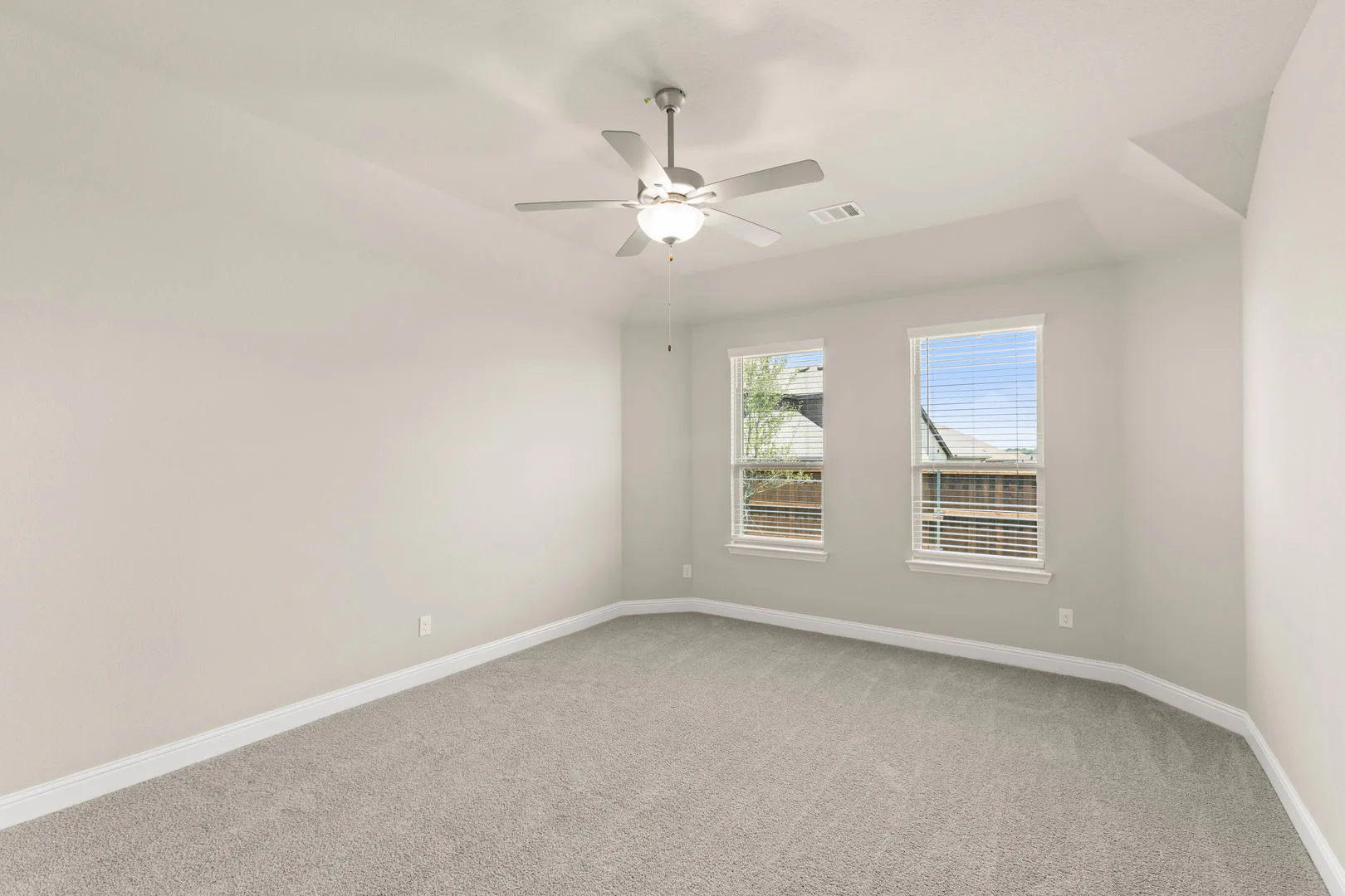Primary suite in a new traditional style home by Kindred Homes