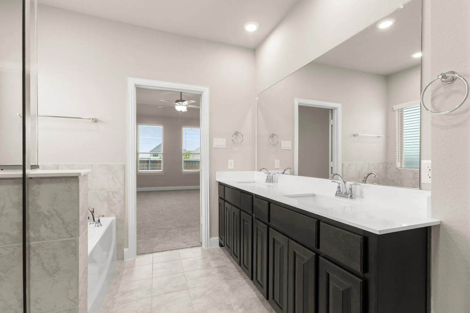 Primary bathroom in a new traditional style home by Kindred Homes