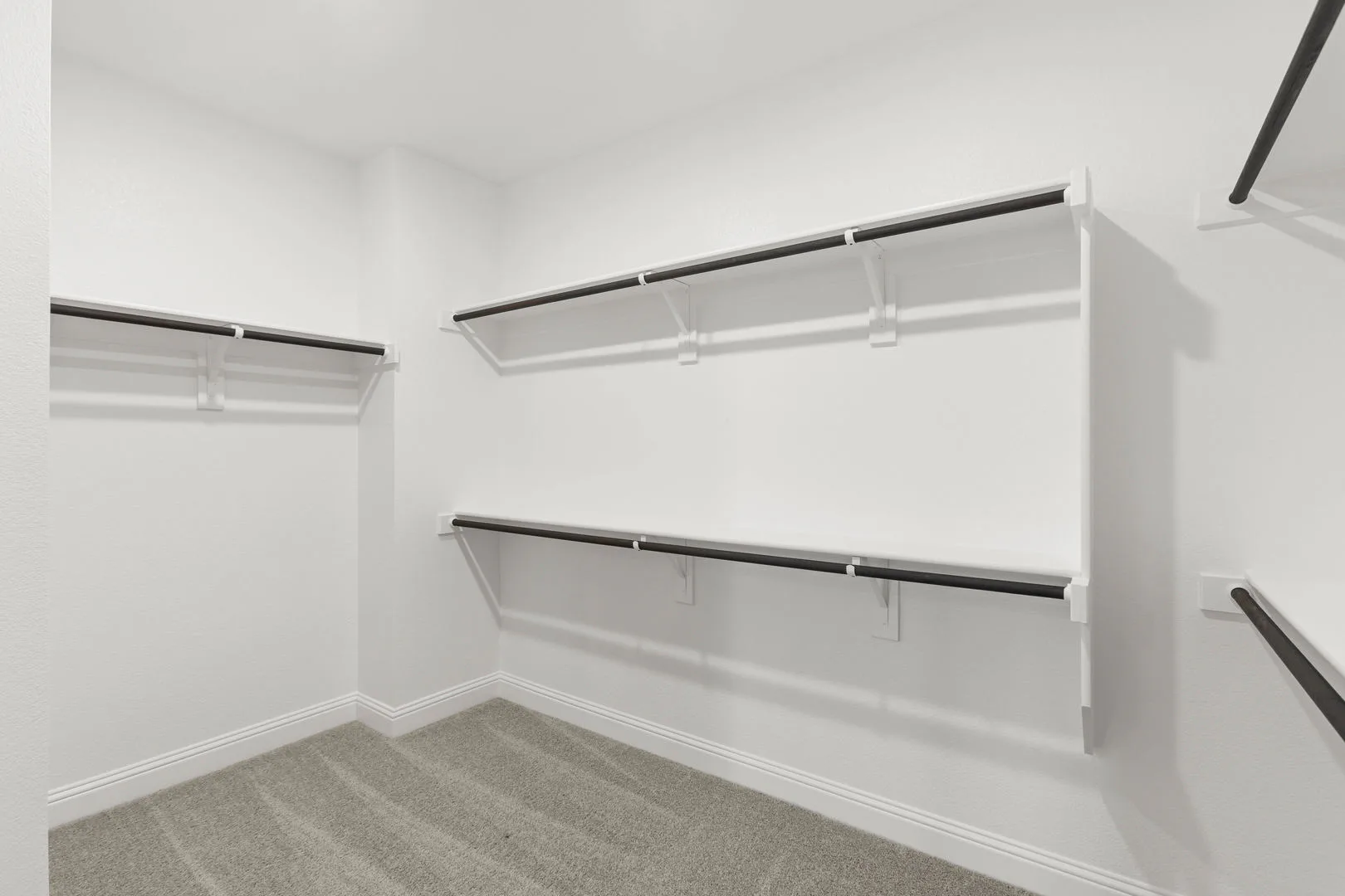 Walk-in closet in a new traditional style home by Kindred Homes