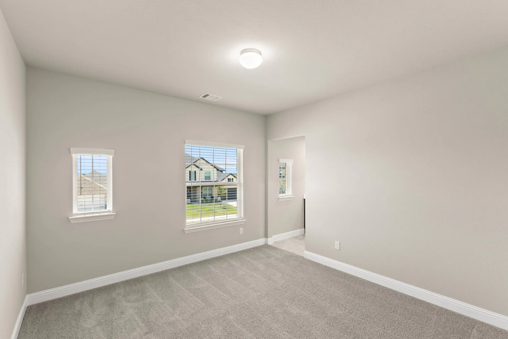 Secondary bedroom in a new traditional style home by Kindred Homes