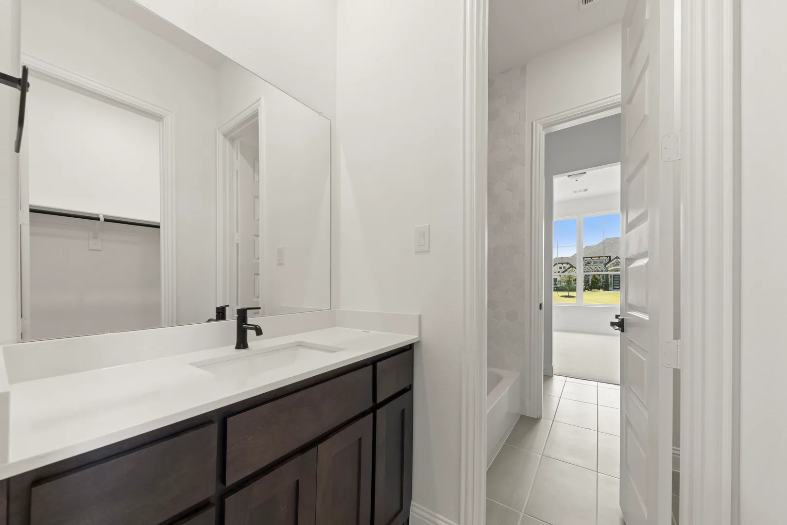 Jack-and-Jill bathroom in a transitional ranch style home by Kindred Homes