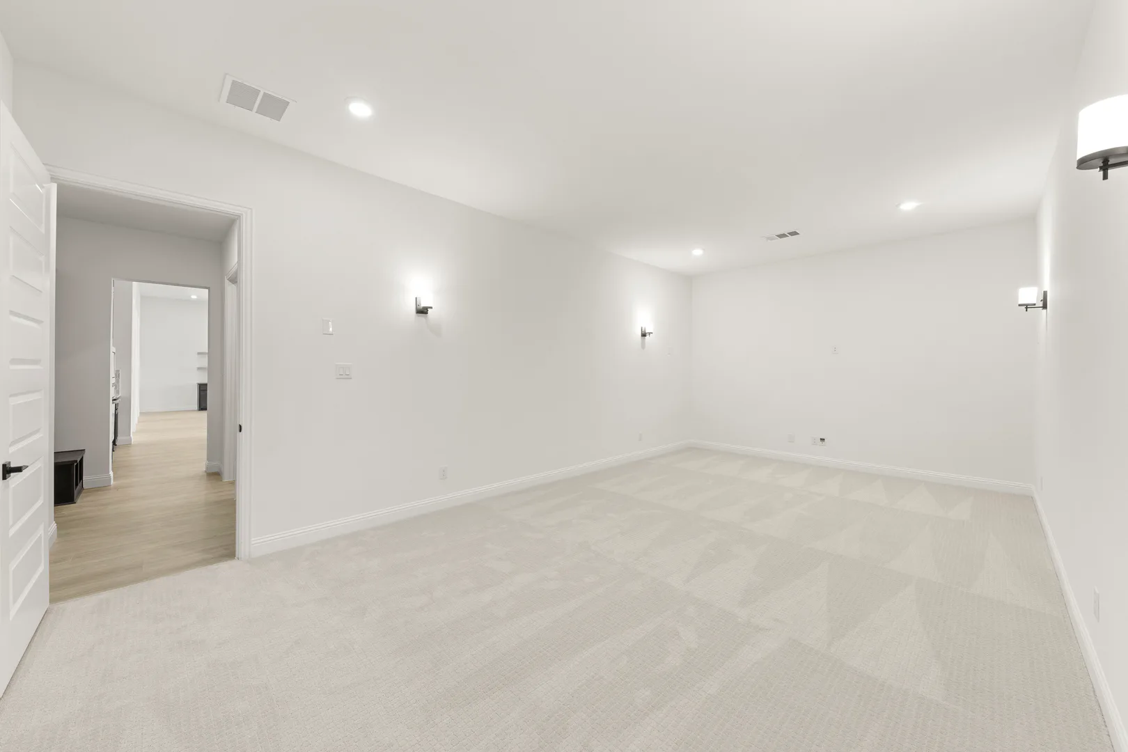 Media room in a transitional ranch style home by Kindred Homes