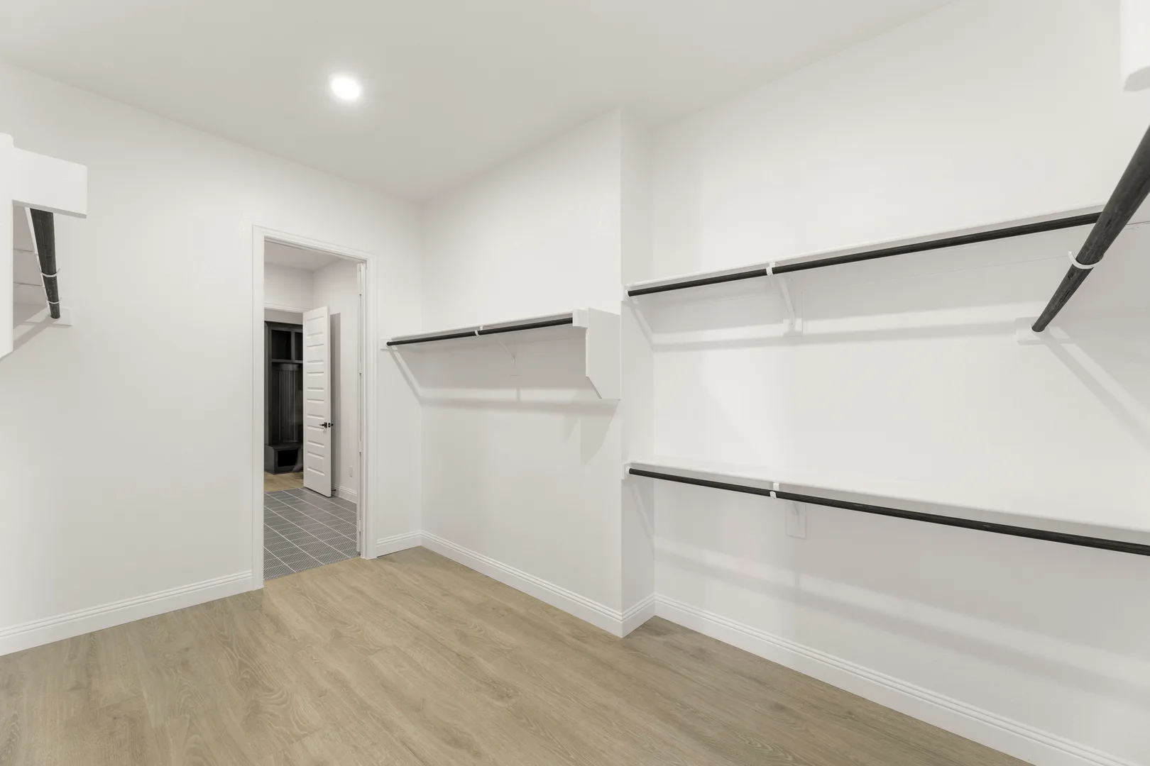 Walk-in closet in a transitional ranch style home by Kindred Homes
