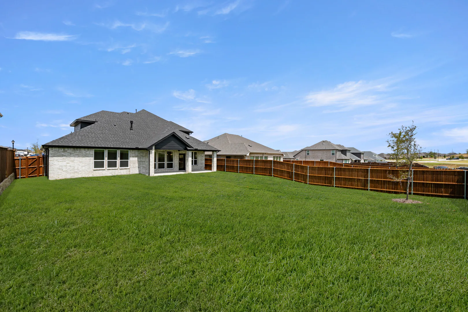 Spacious backyard of a new traditional style home by Kindred Homes