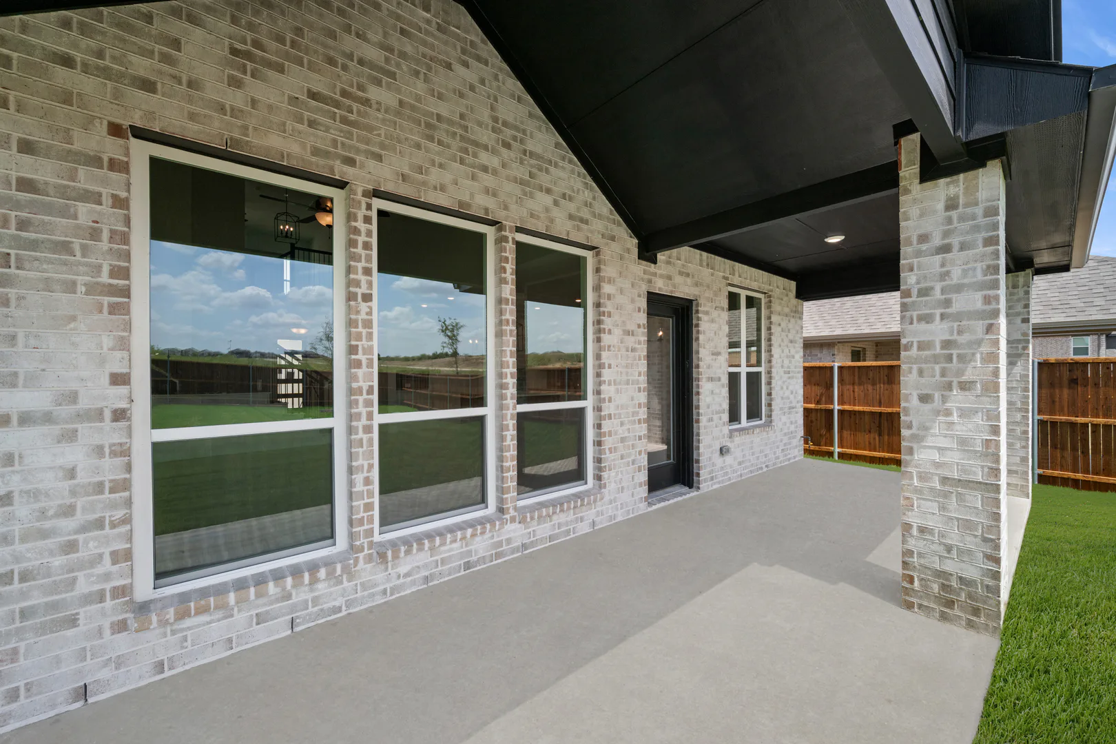 Covered patio of a new traditional style home by Kindred Homes