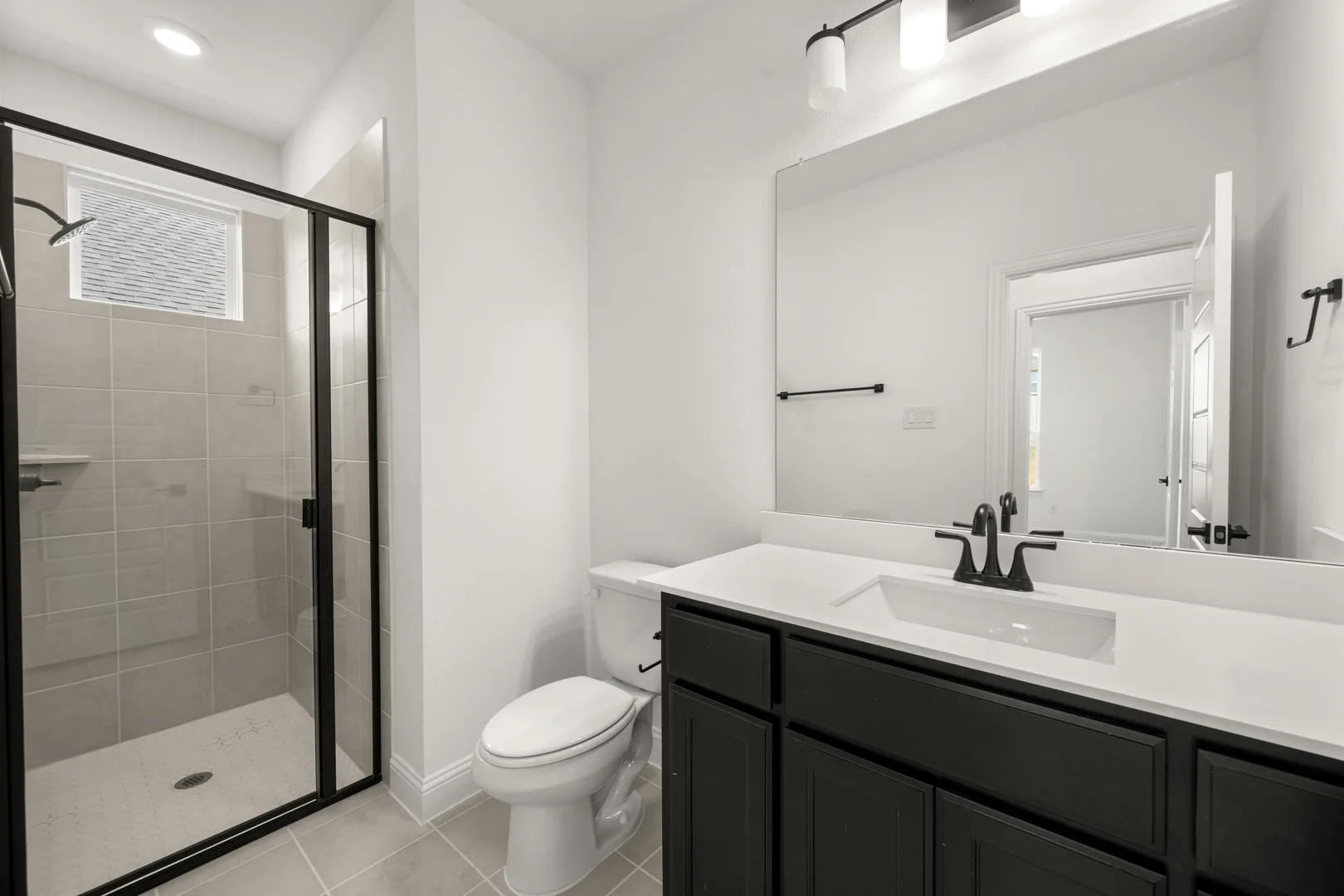 Secondary bathroom in a new traditional style home by Kindred Homes