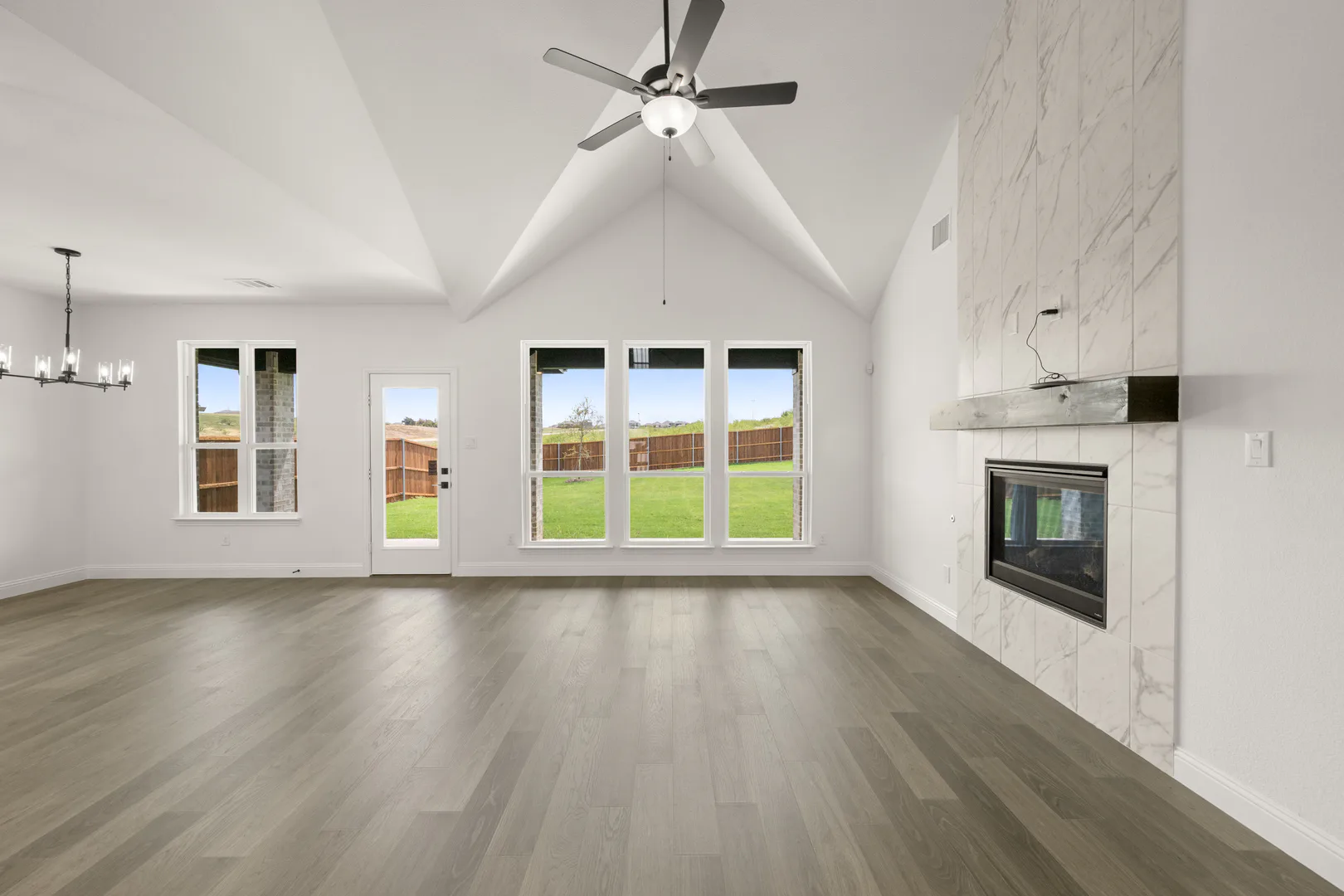 Living room with fireplace in a new traditional style home by Kindred Homes