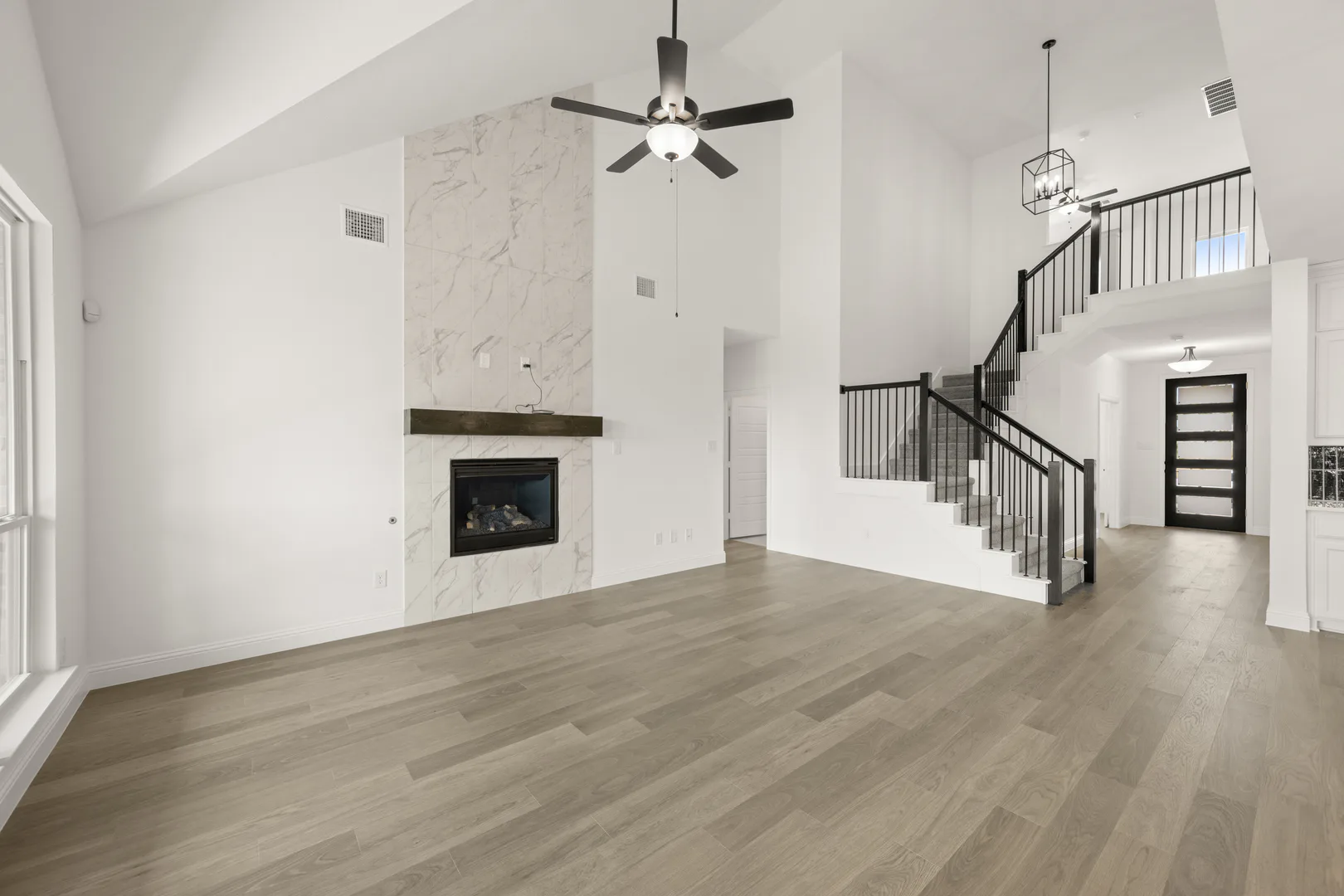 Living room with fireplace in a new traditional style home by Kindred Homes