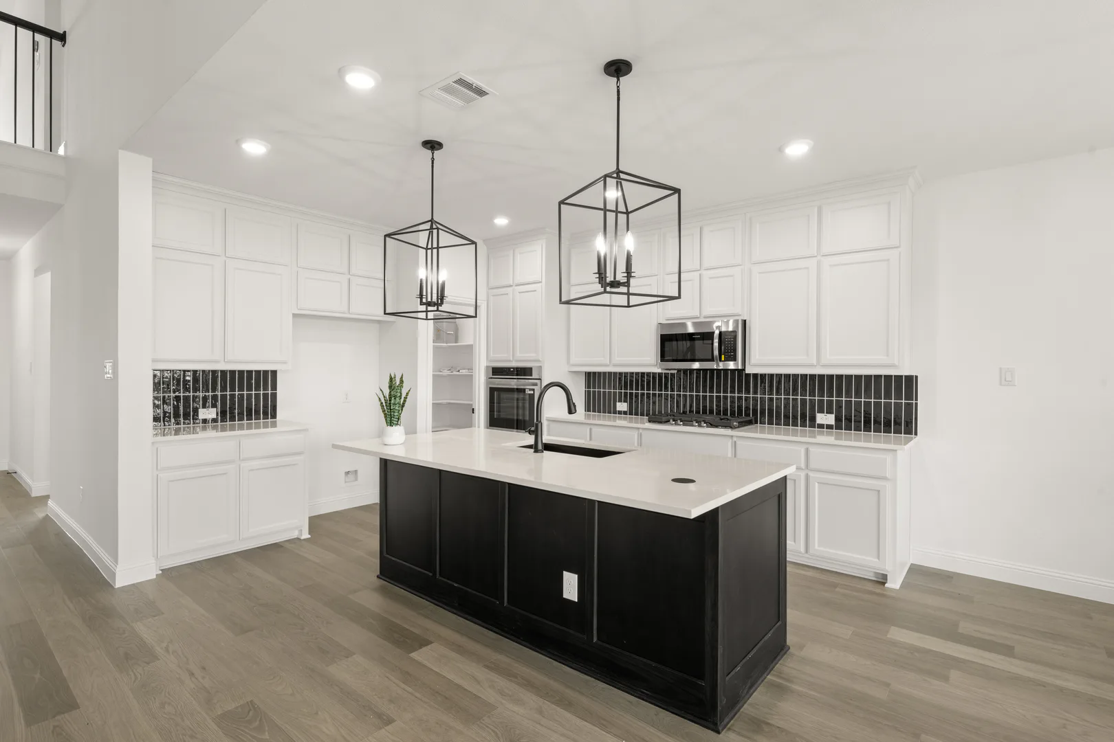 Kitchen in a new traditional style home by Kindred Homes