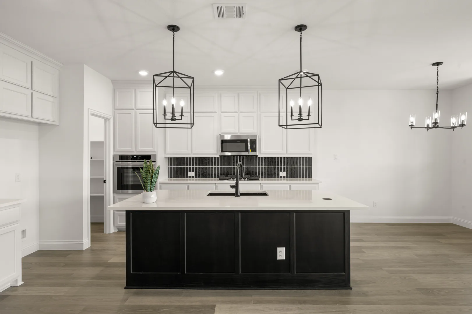 Kitchen and breakfast nook in a new traditional style home by Kindred Homes