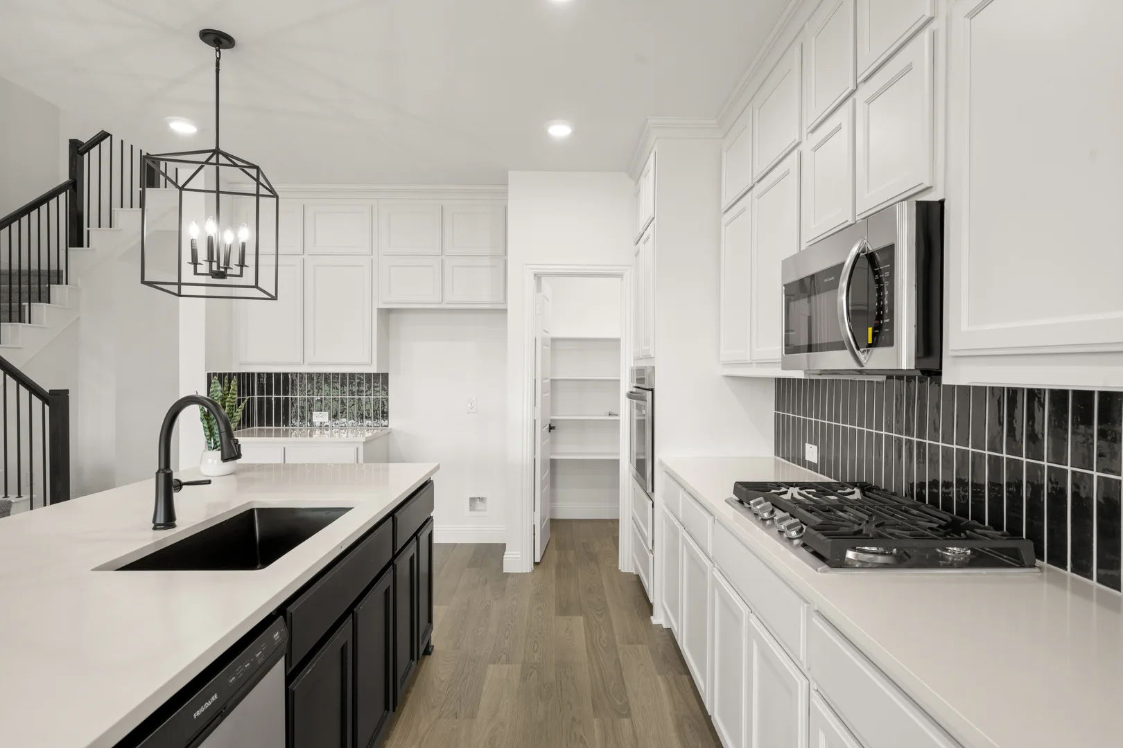 Kitchen in a new traditional style home by Kindred Homes