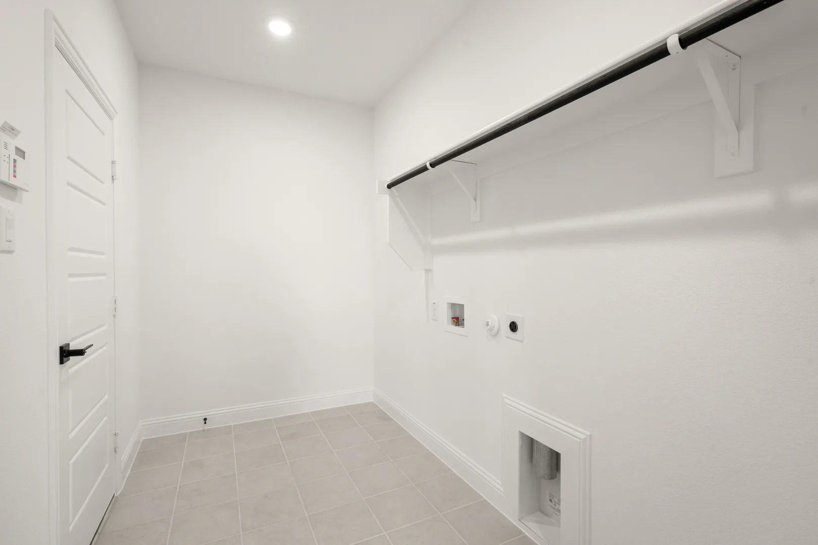 Utility room in a new traditional style home by Kindred Homes