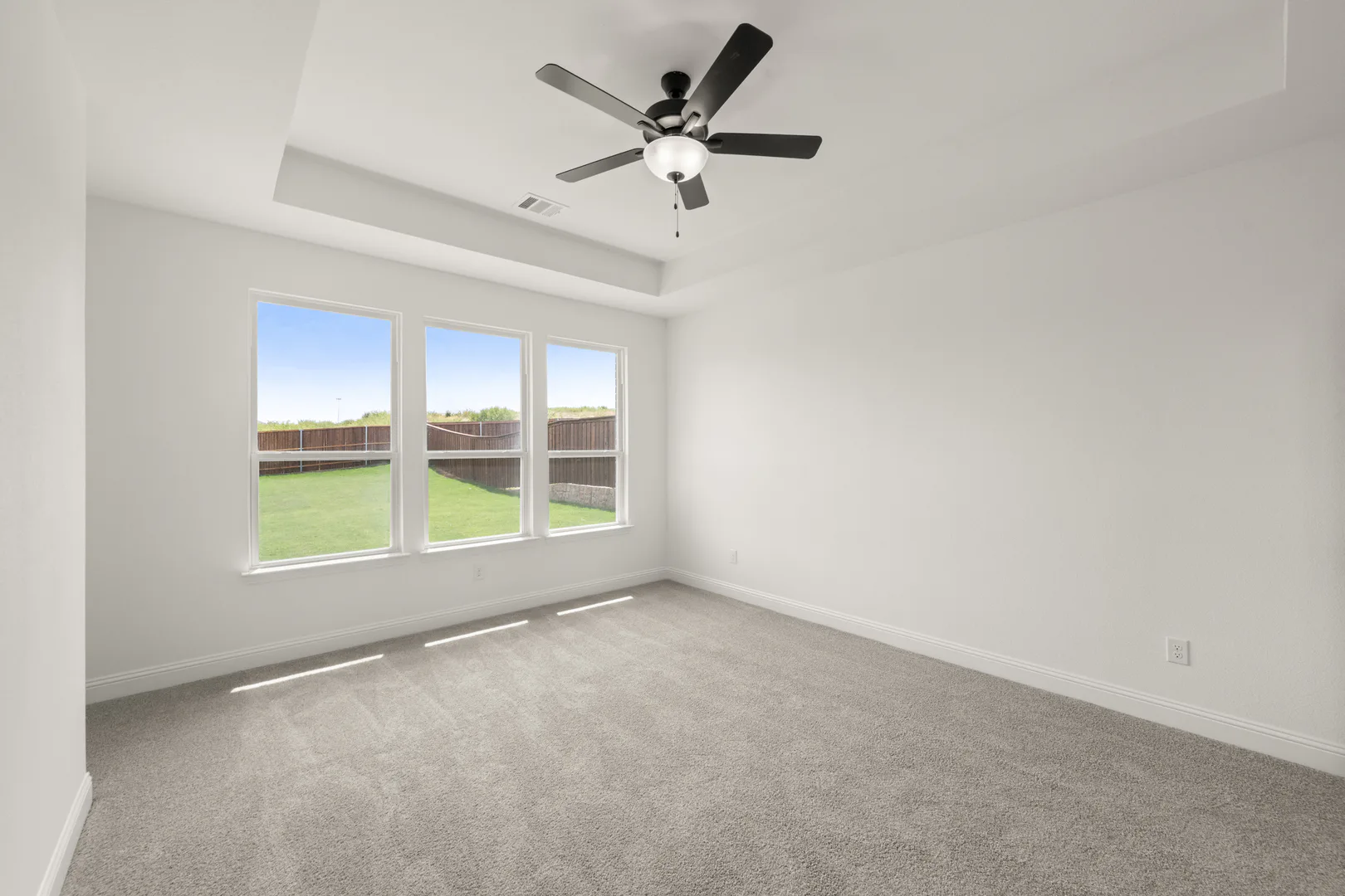 Primary bedroom in a new traditional style home by Kindred Homes