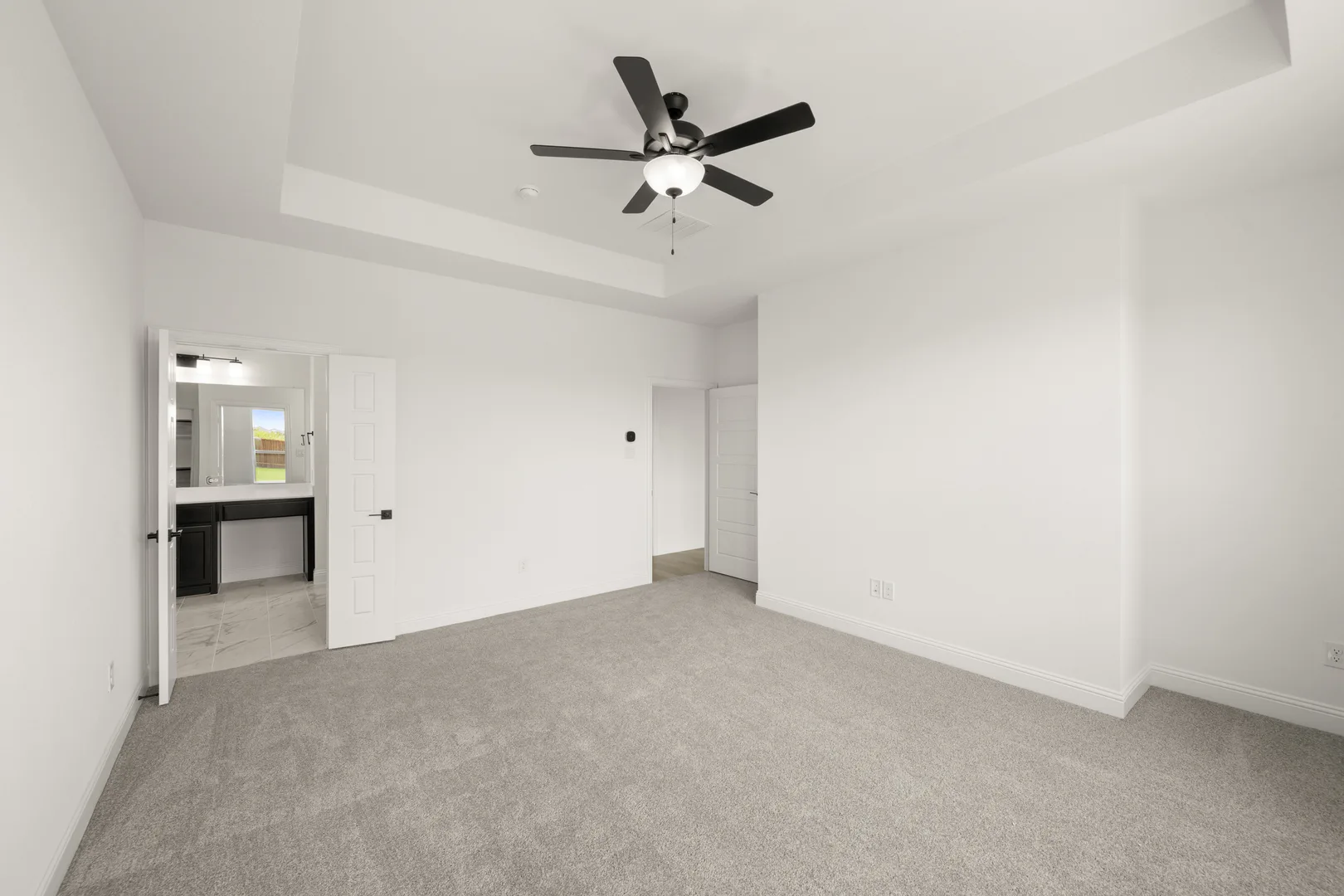 Primary bedroom in a new traditional style home by Kindred Homes