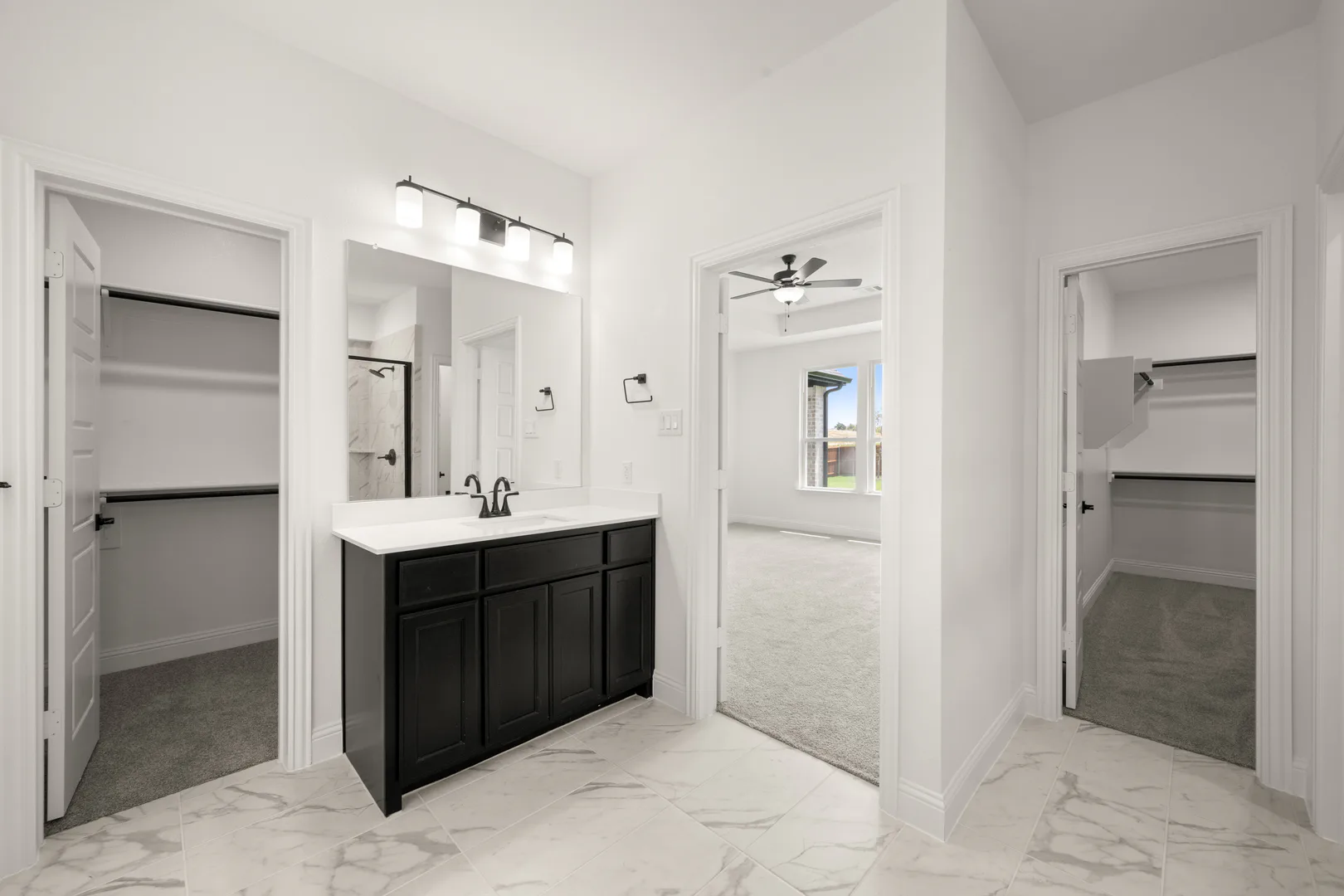 Primary bathroom in a new traditional style home by Kindred Homes