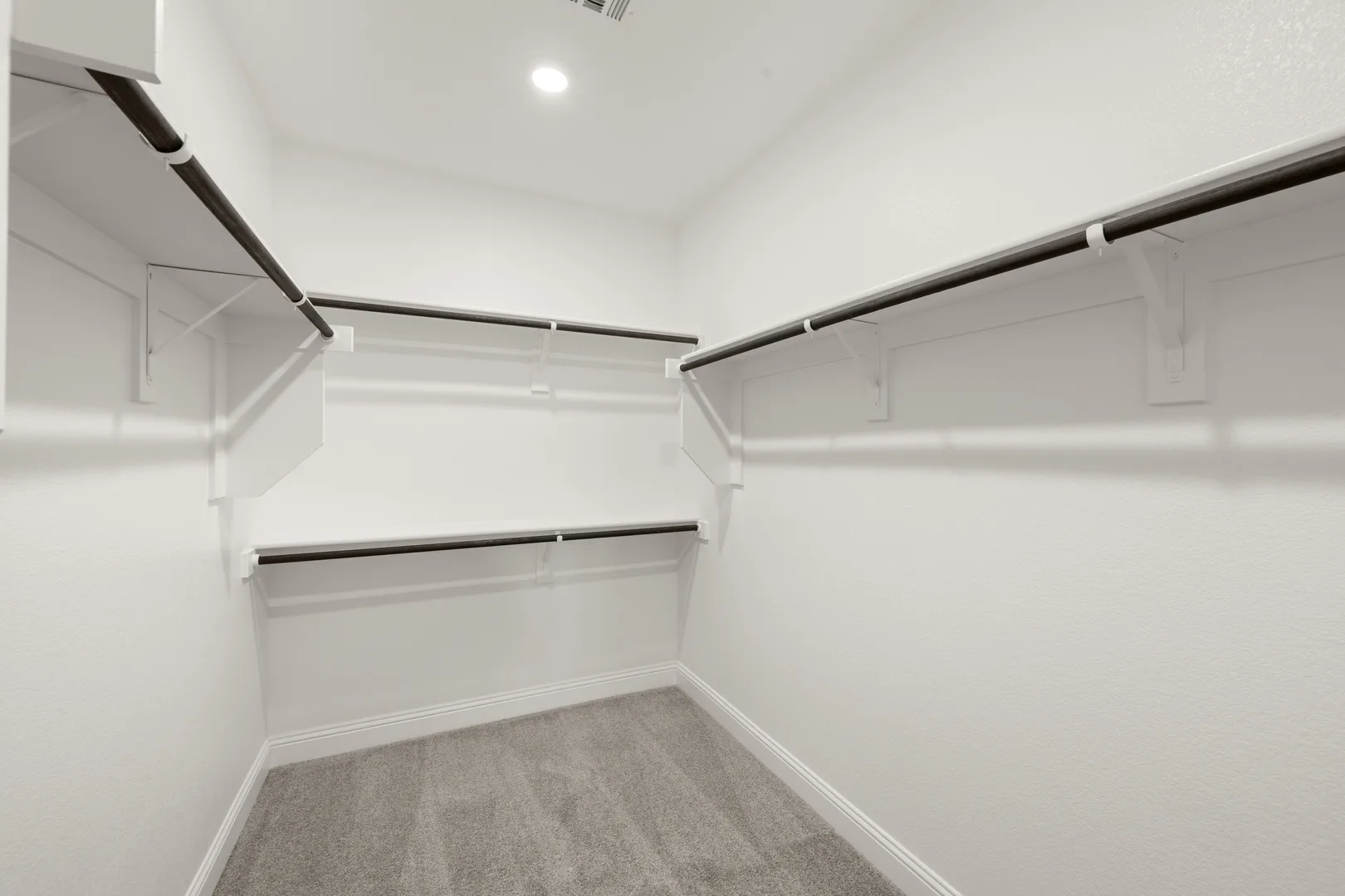Walk-in closet in a new traditional style home by Kindred Homes