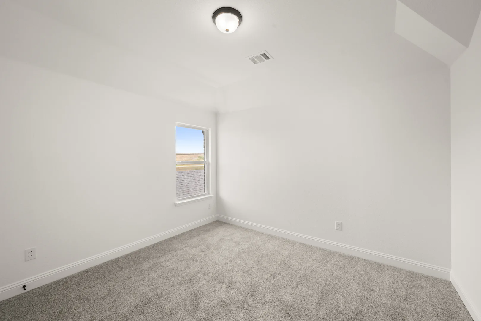 Secondary bedroom in a new traditional style home by Kindred Homes