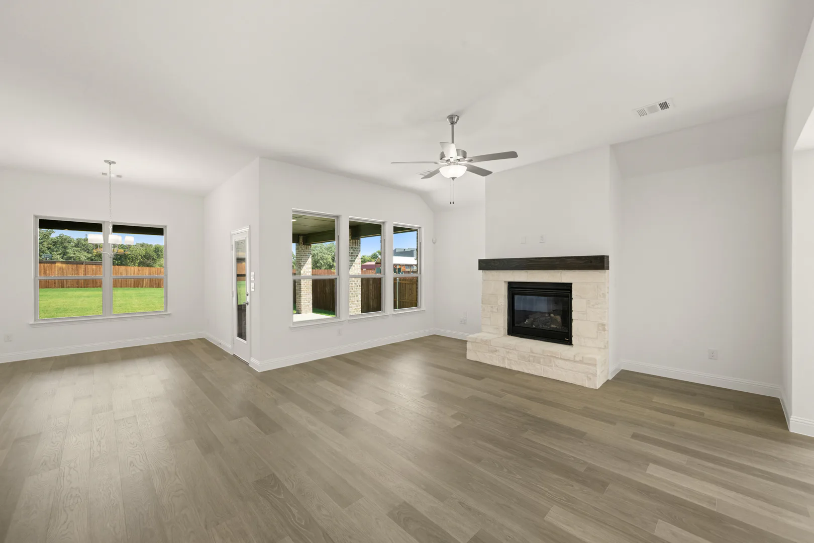 Living room with fireplace in a modern farmhouse transitional style home by Kindred Homes