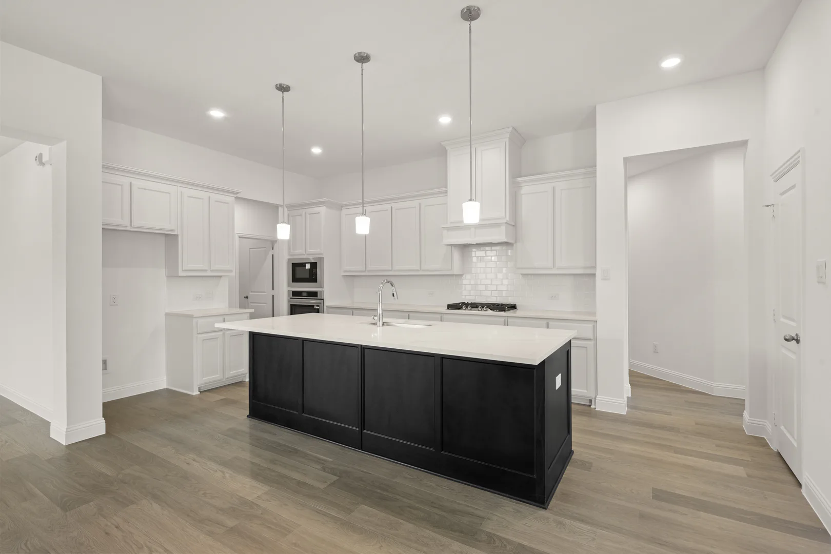 Kitchen in a modern farmhouse transitional style home by Kindred Homes