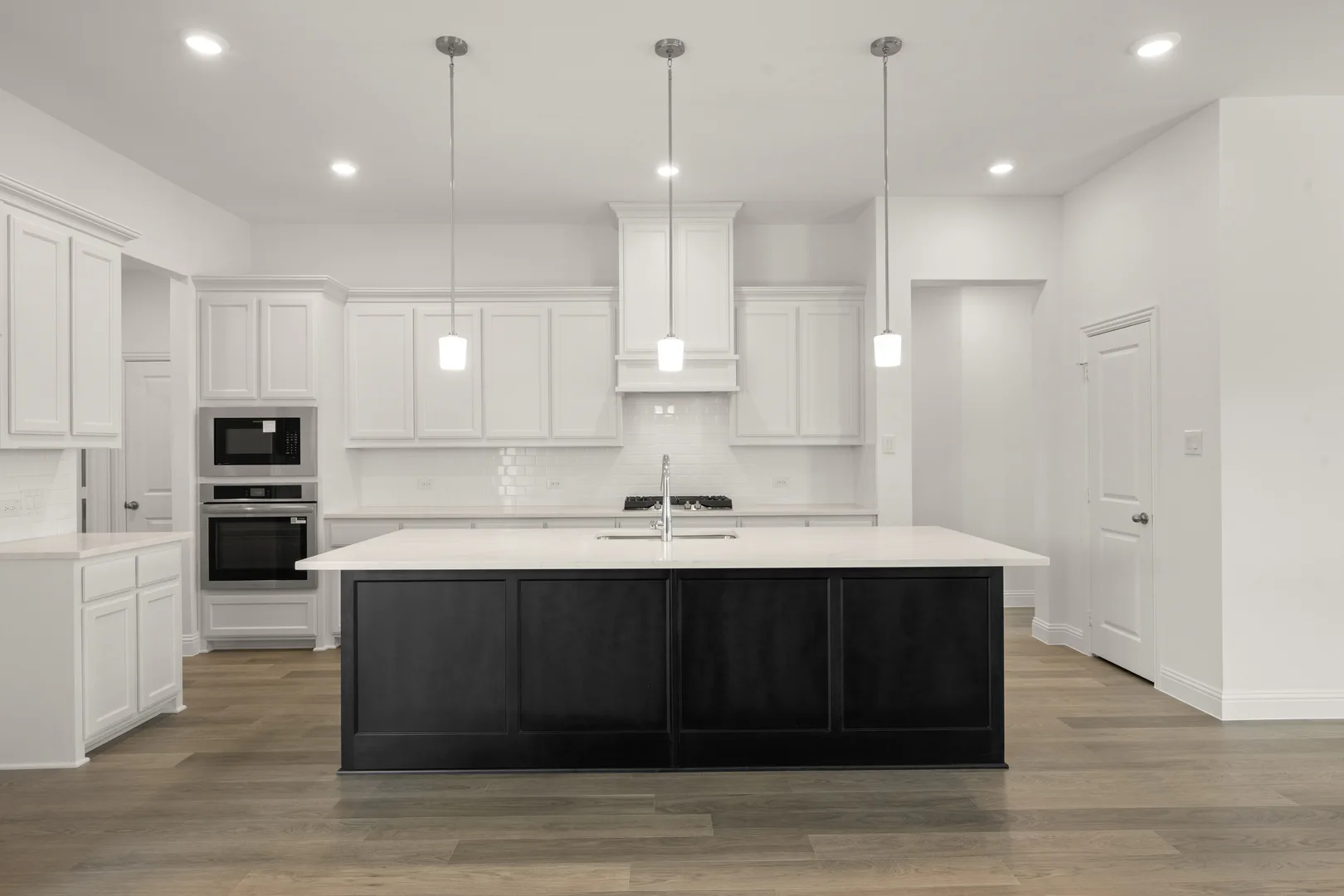 Kitchen in a modern farmhouse transitional style home by Kindred Homes