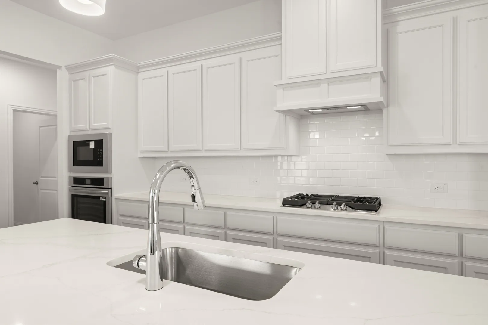 Close up of kitchen in a modern farmhouse transitional style home by Kindred Homes