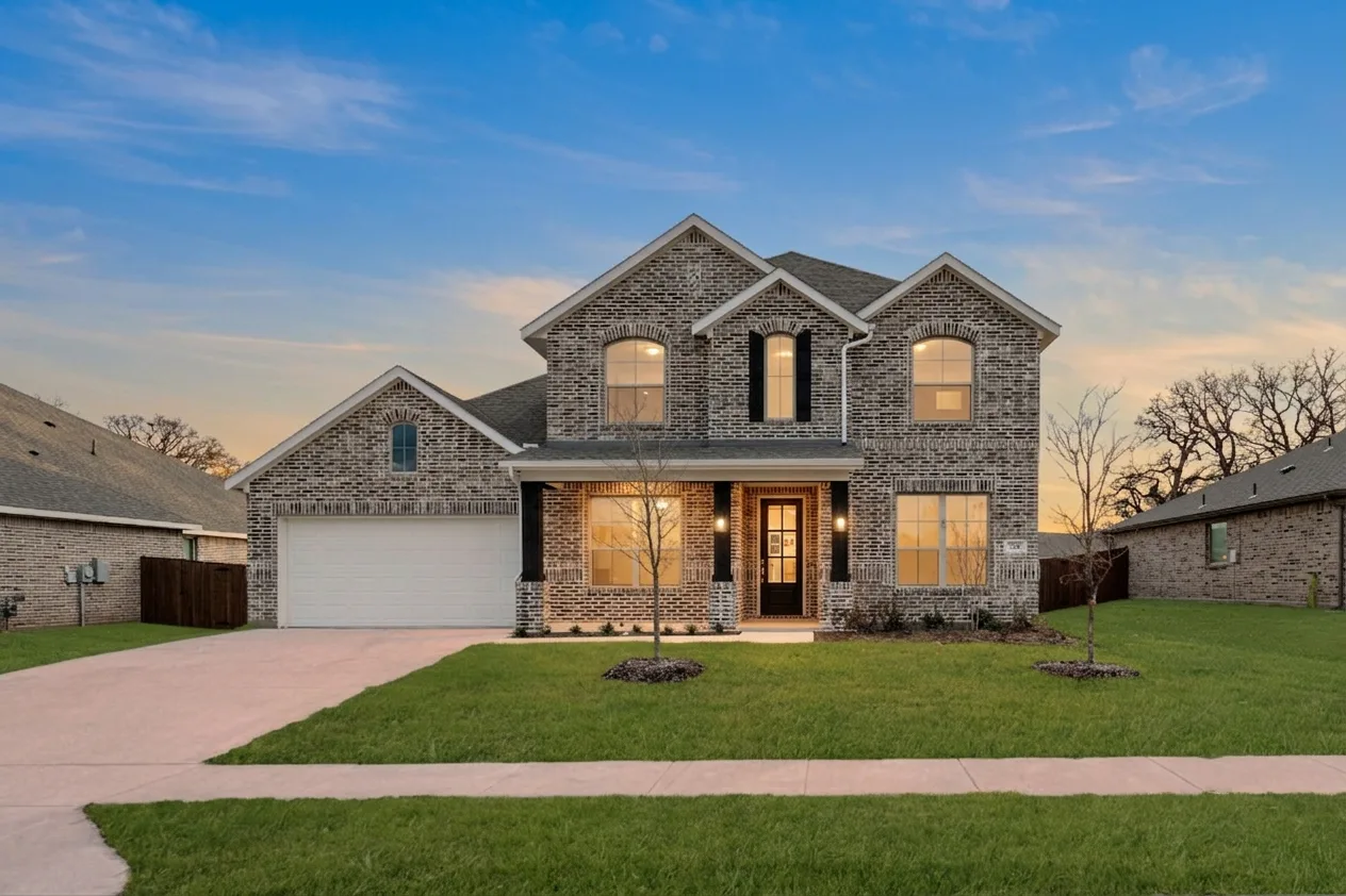 Front exterior of a new traditional style home by Kindred Homes