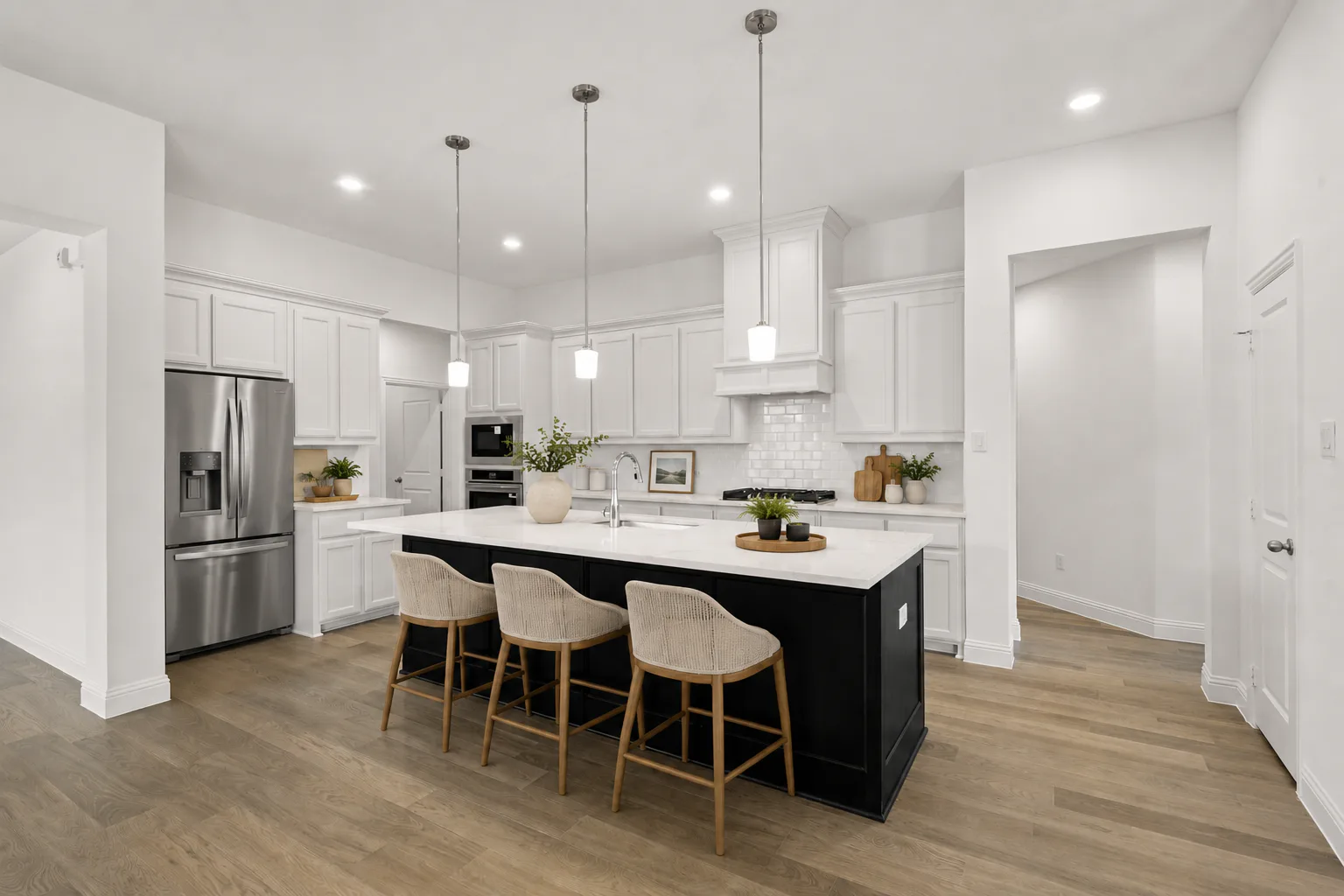 Virtually staged kitchen in a modern farmhouse transitional style home by Kindred Homes
