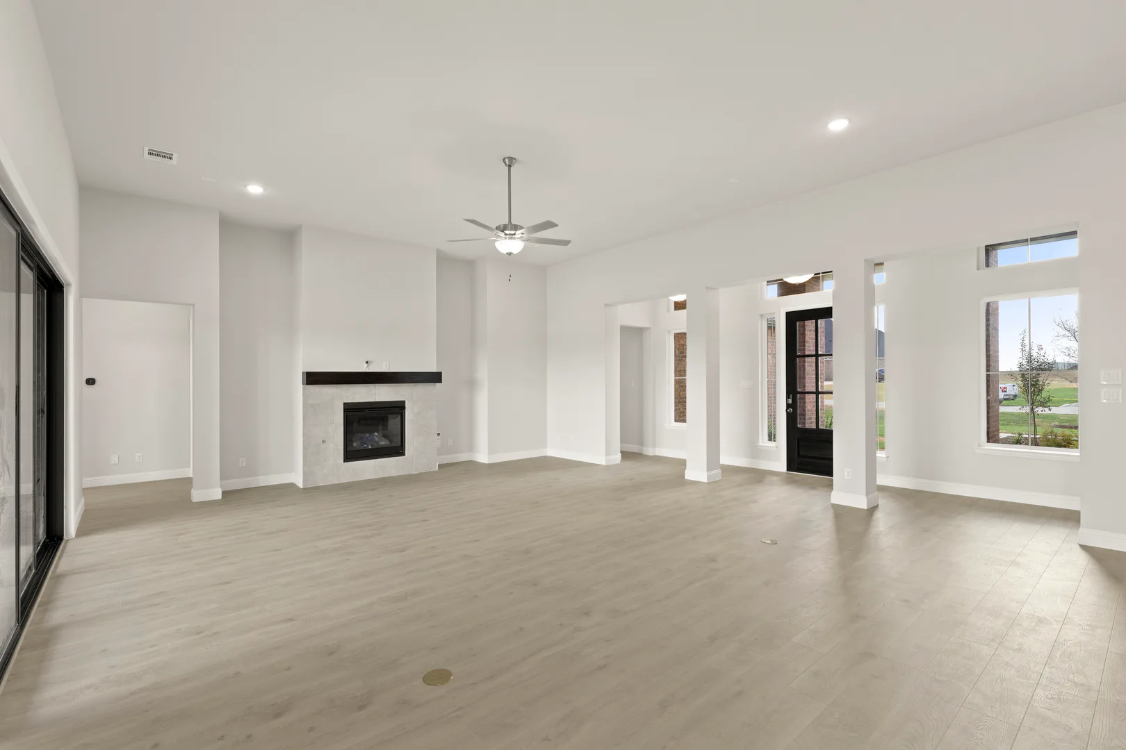Living room with fireplace in a transitional ranch style home by Kindred Homes
