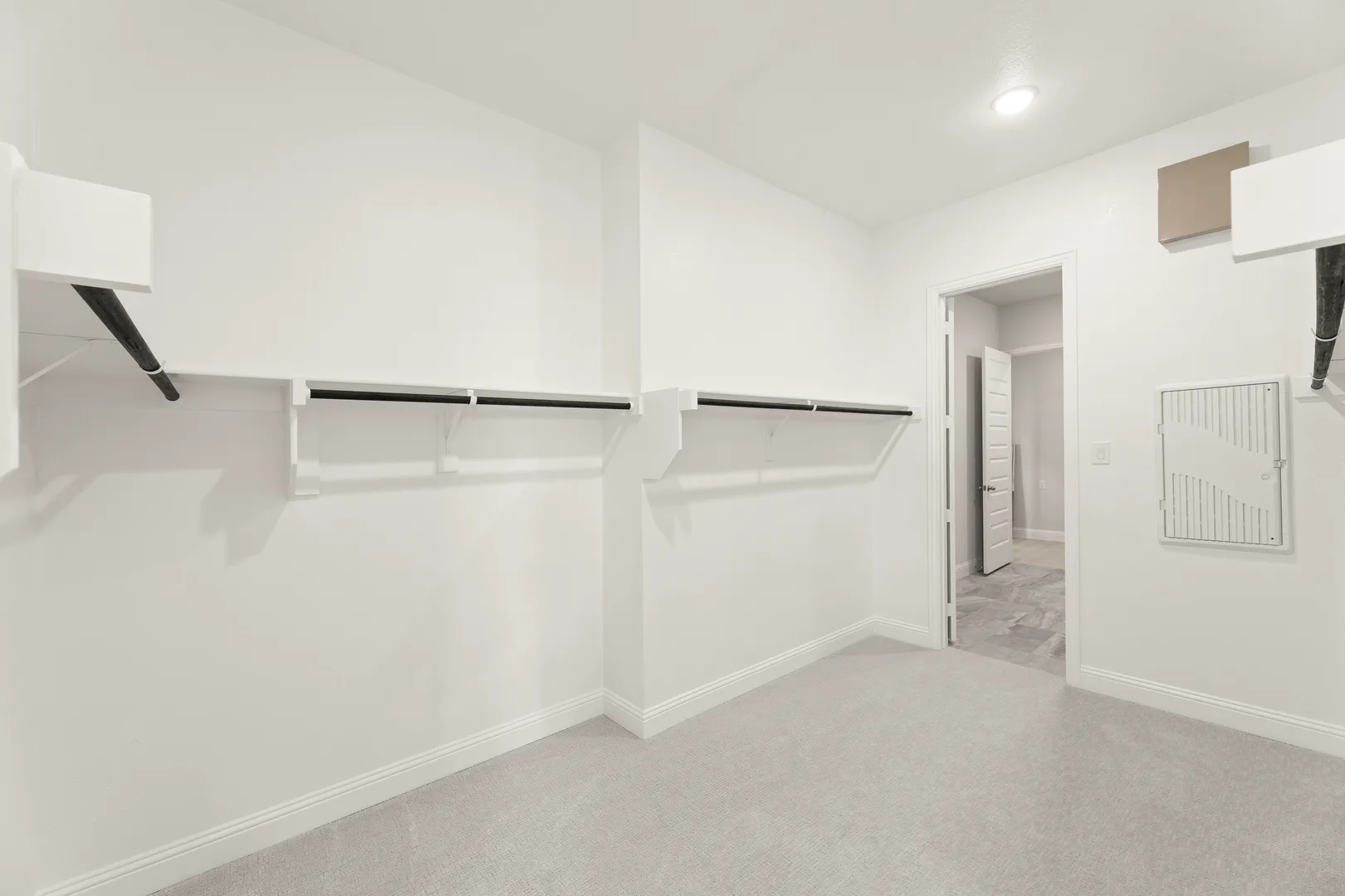 Walk-in closet in a transitional ranch style home by Kindred Homes