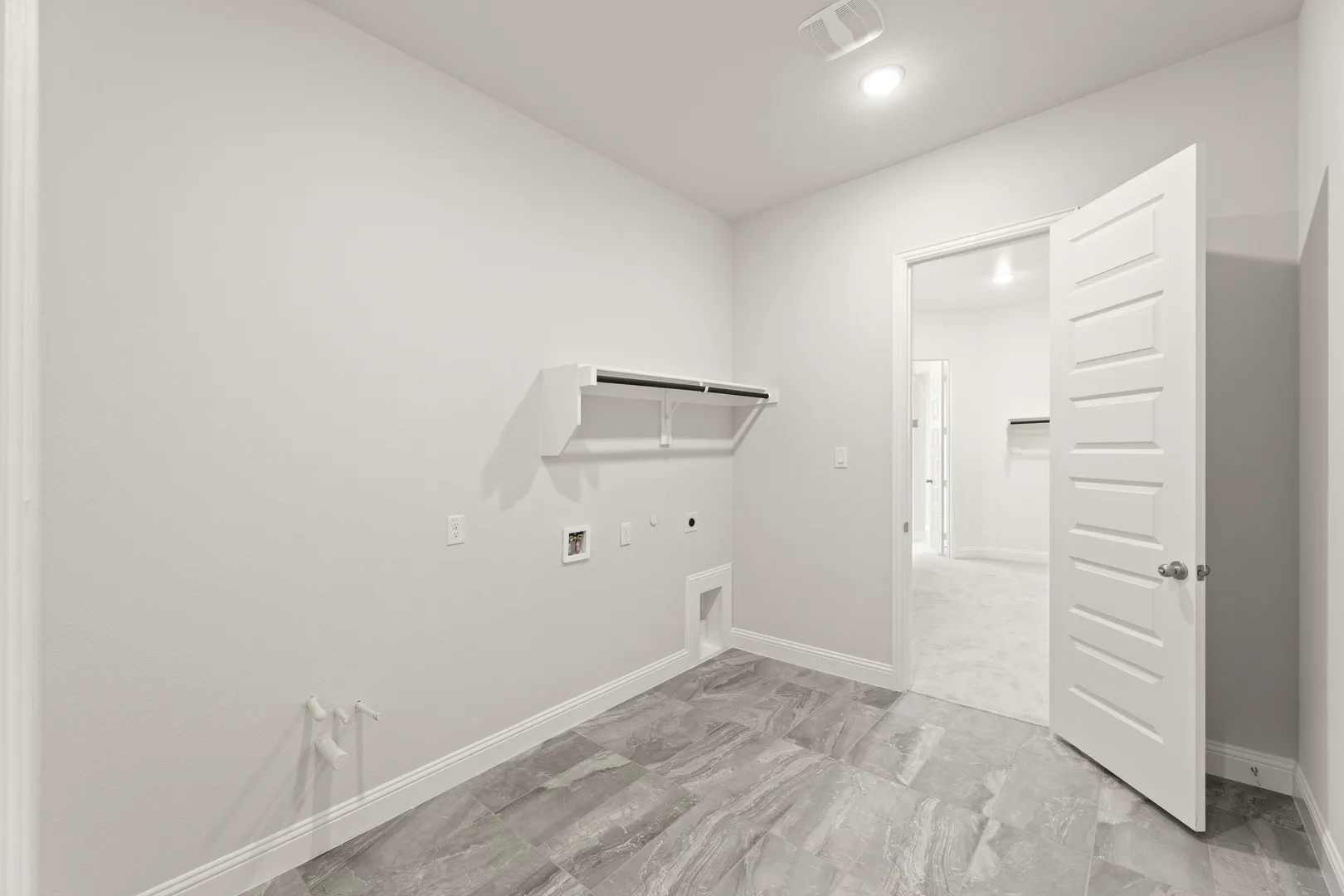 Utility room in a transitional ranch style home by Kindred Homes