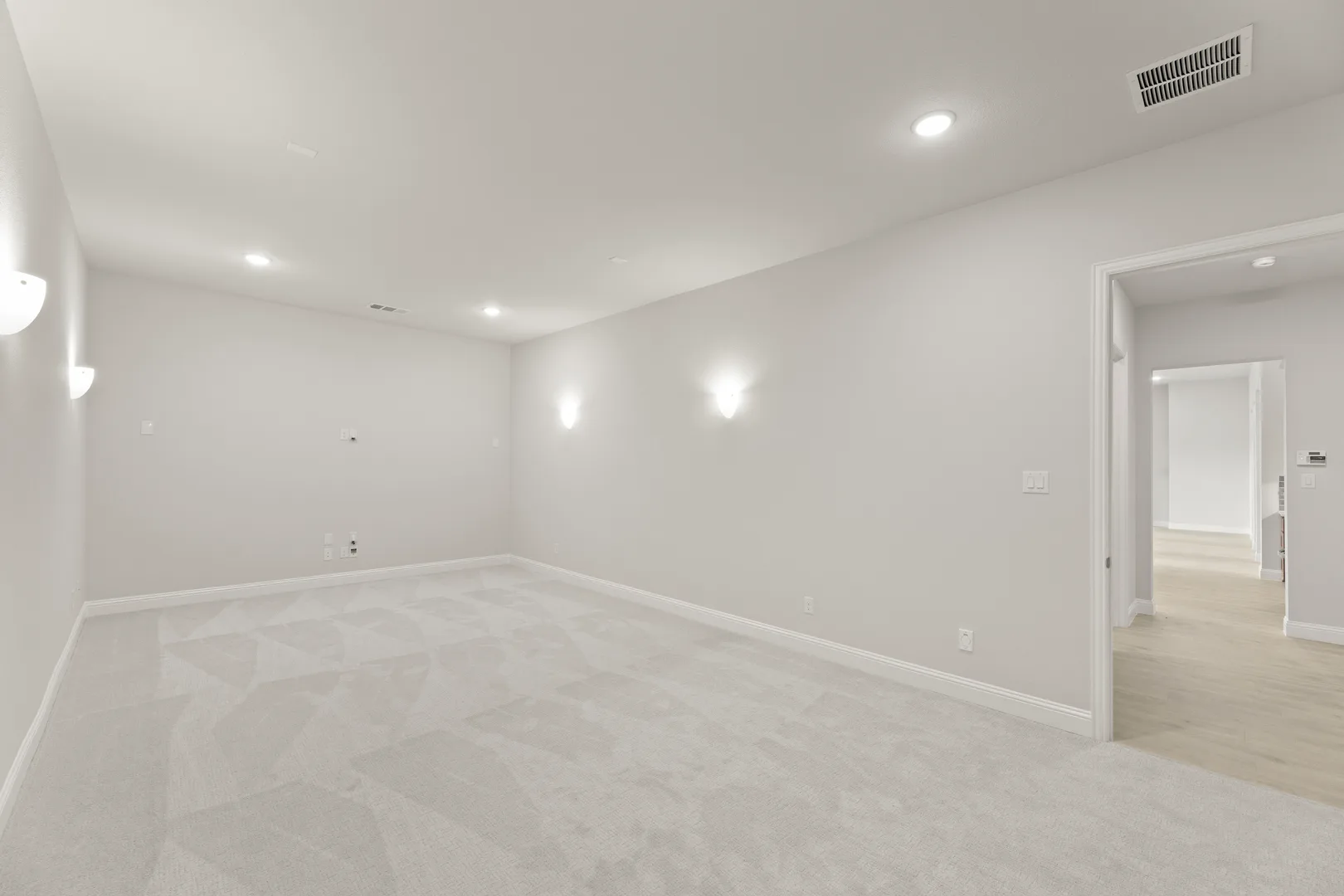 Media room in a transitional ranch style home by Kindred Homes