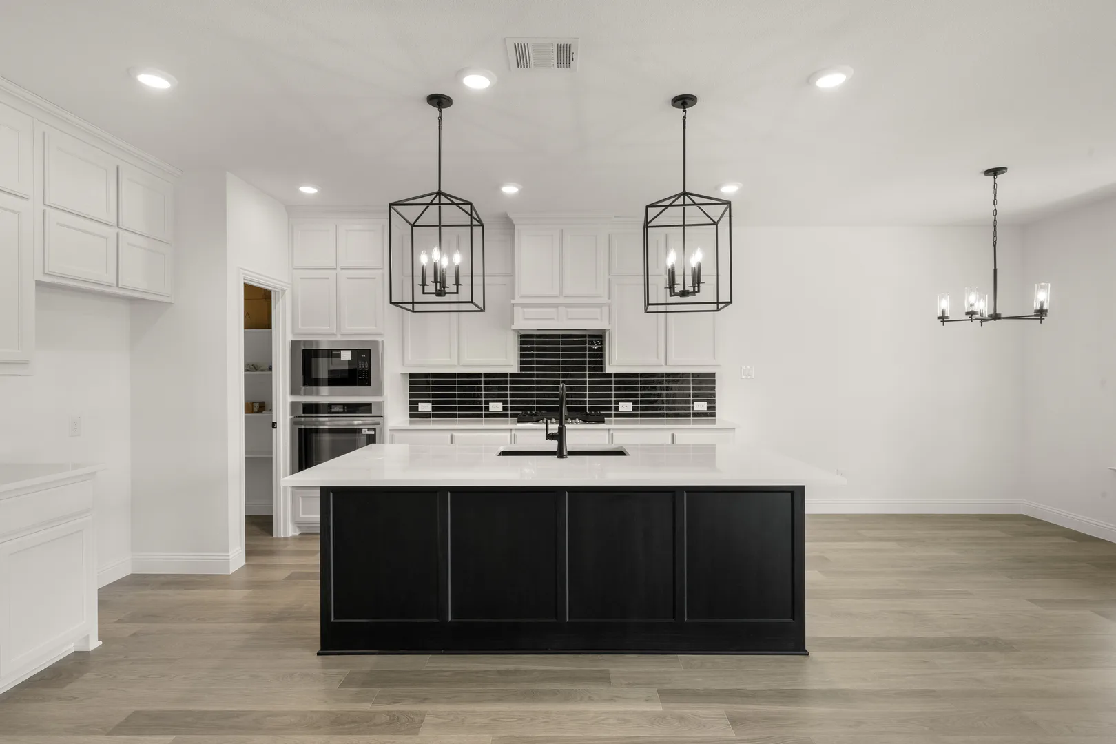 Kitchen in a new traditional style home by Kindred Homes