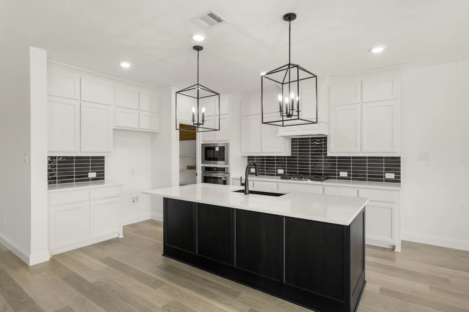 Side view of kitchen in a new traditional style home by Kindred Homes
