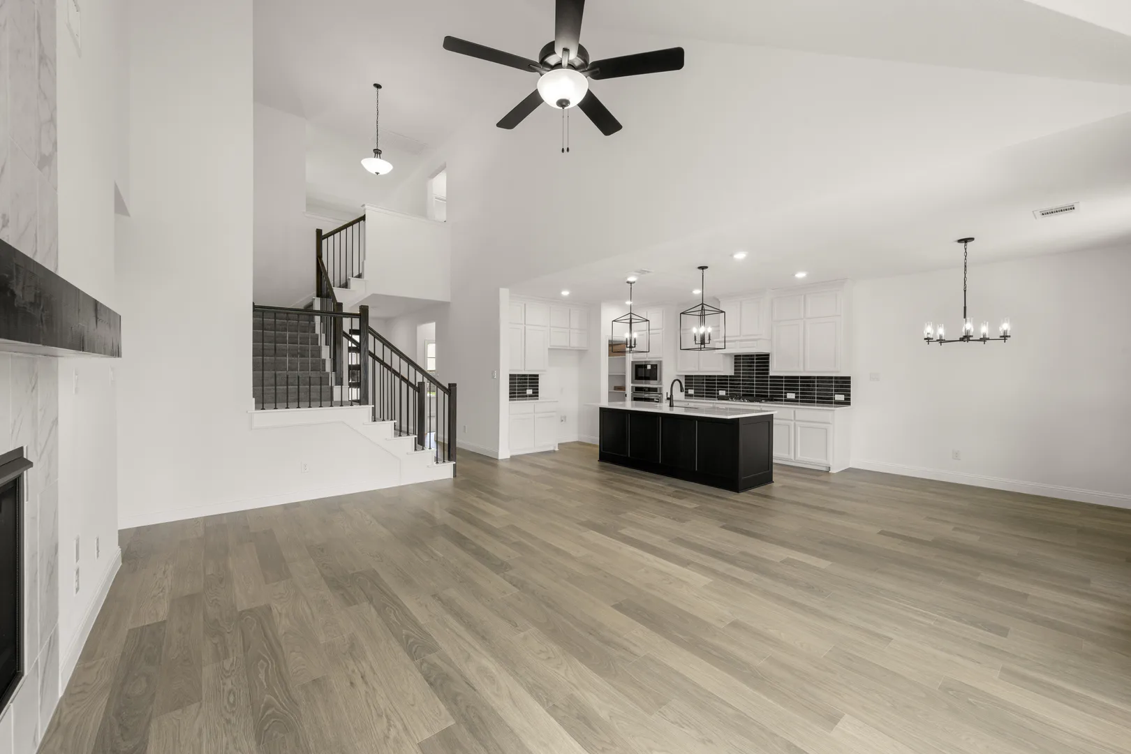 Living room and kitchen in a new traditional style home by Kindred Homes