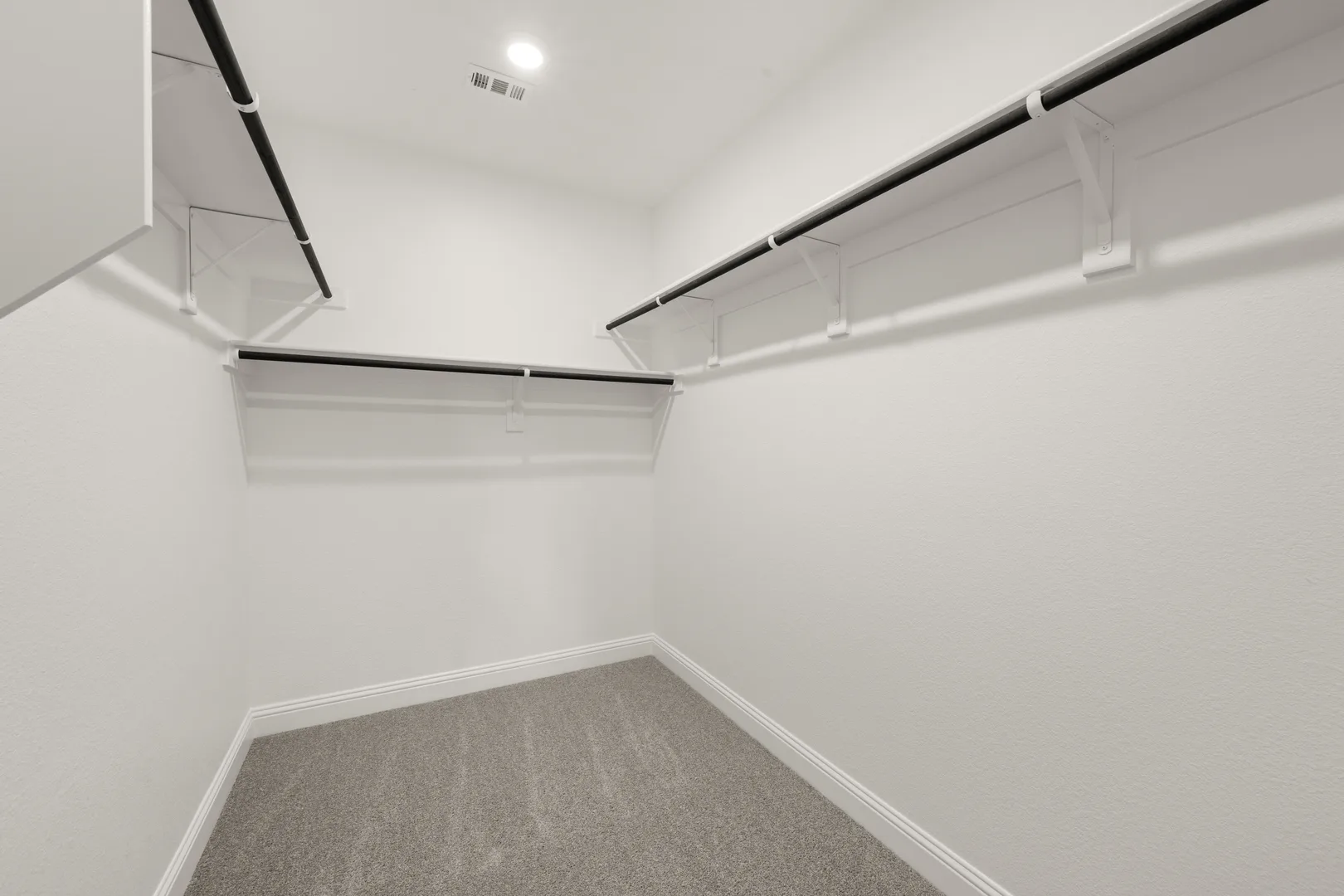 Walk-in closet in a new traditional style home by Kindred Homes