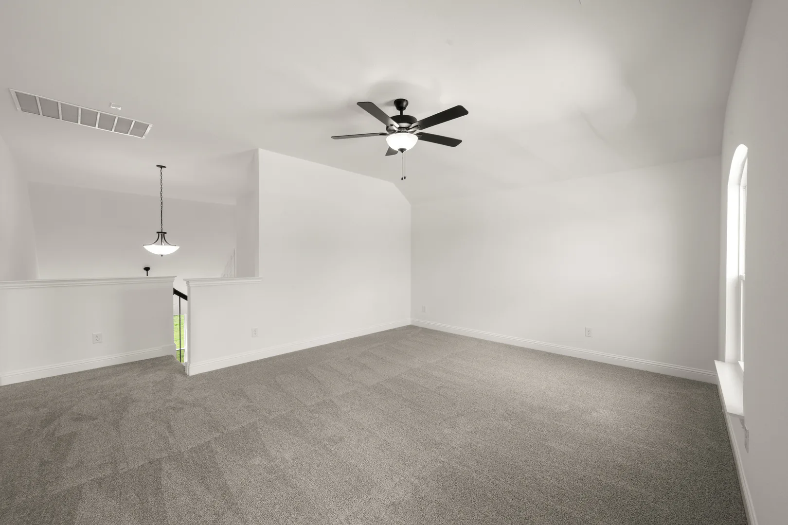 Spacious game room in a new traditional style home by Kindred Homes