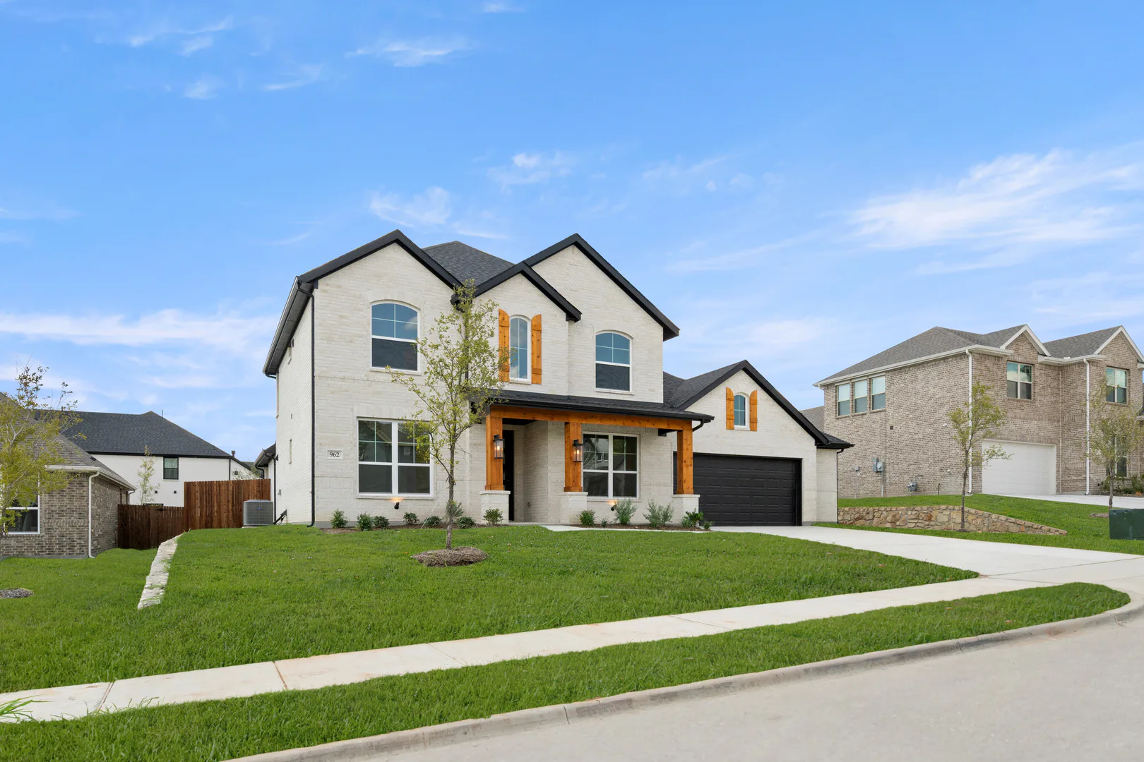 Side view of exterior of a new traditional style home by Kindred Homes