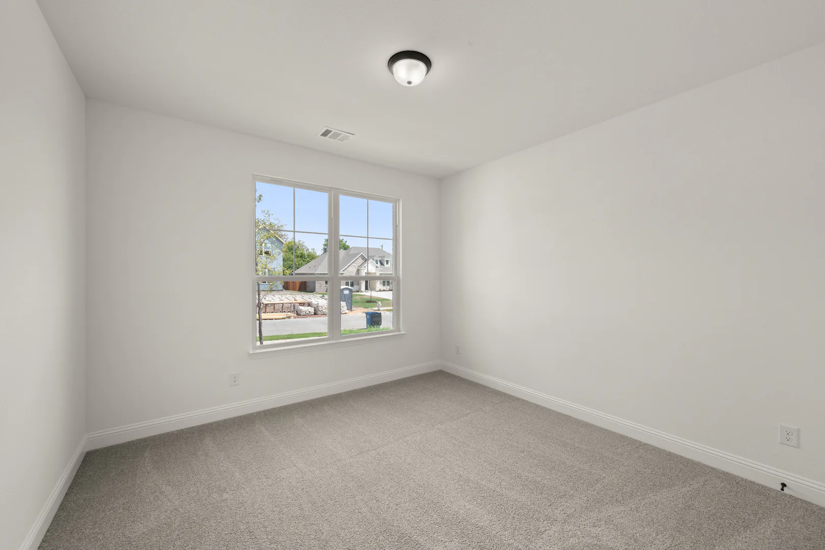 Secondary bedroom in a new traditional style home by Kindred Homes