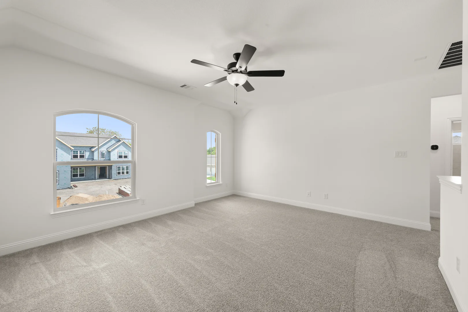 Spacious game room in a new traditional style home by Kindred Homes