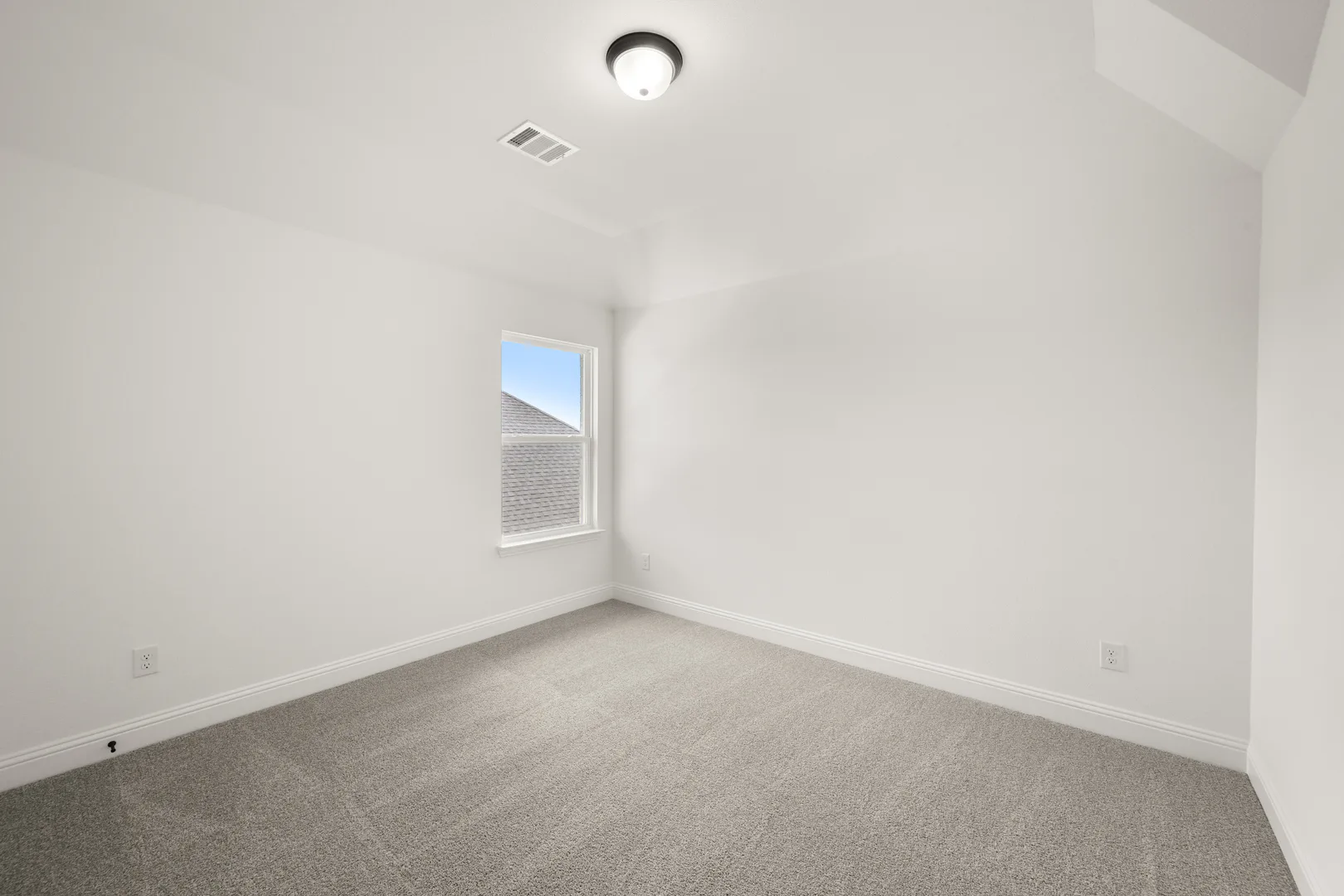 Secondary bedroom in a new traditional style home by Kindred Homes