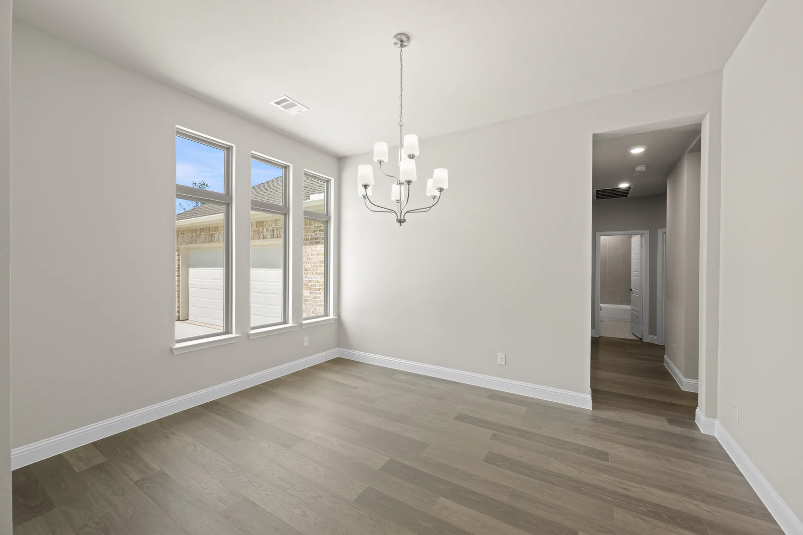 Dining room in a transitional ranch style home by Kindred Homes