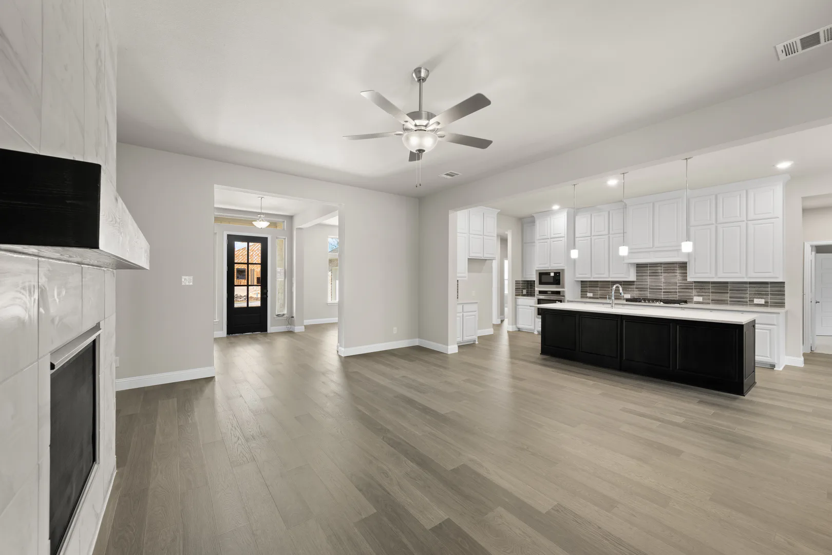 Kitchen and living room in a transitional ranch style home by Kindred Homes