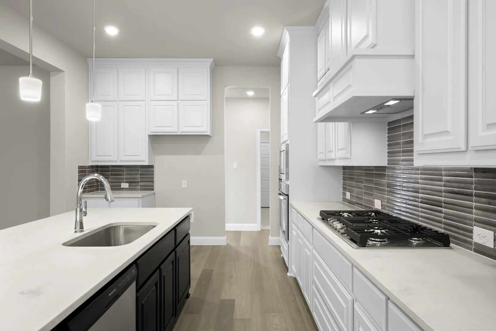 Kitchen with stainless steel appliances in a transitional ranch style home by Kindred Homes