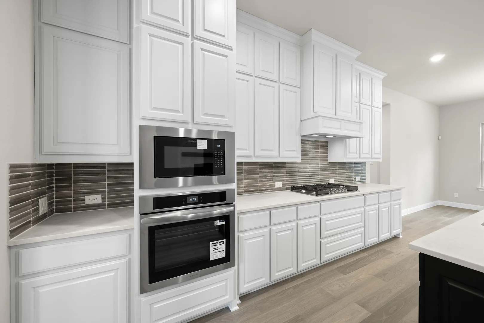 Kitchen with stainless steel appliances in a transitional ranch style home by Kindred Homes