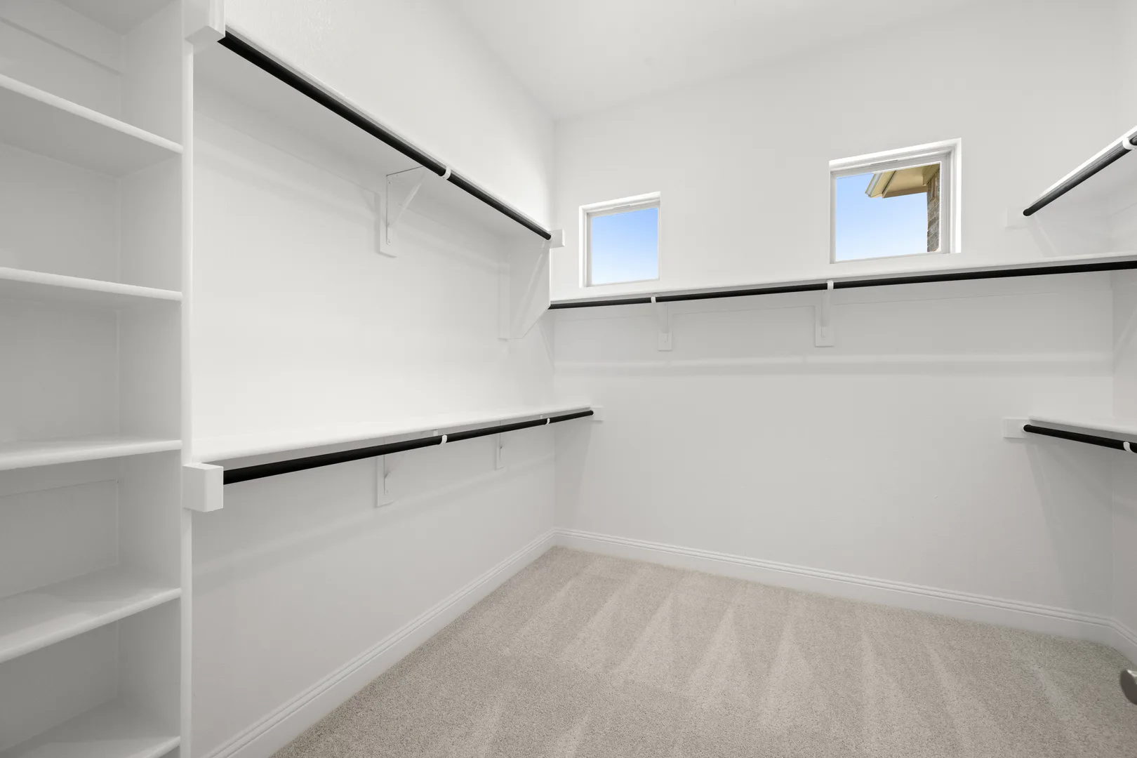 Walk-in closet in a transitional ranch style home by Kindred Homes