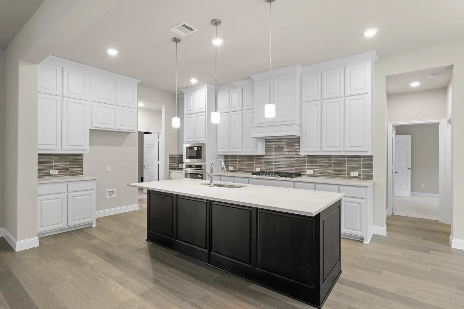 Kitchen in a transitional ranch style home by Kindred Homes