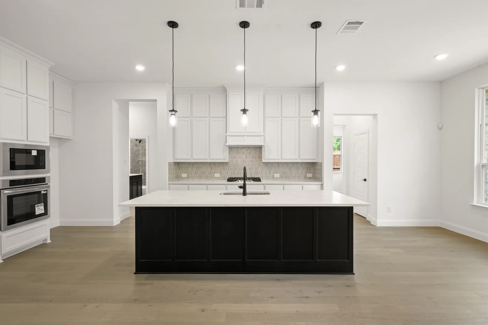 Kitchen in a transitional ranch style home by Kindred Homes