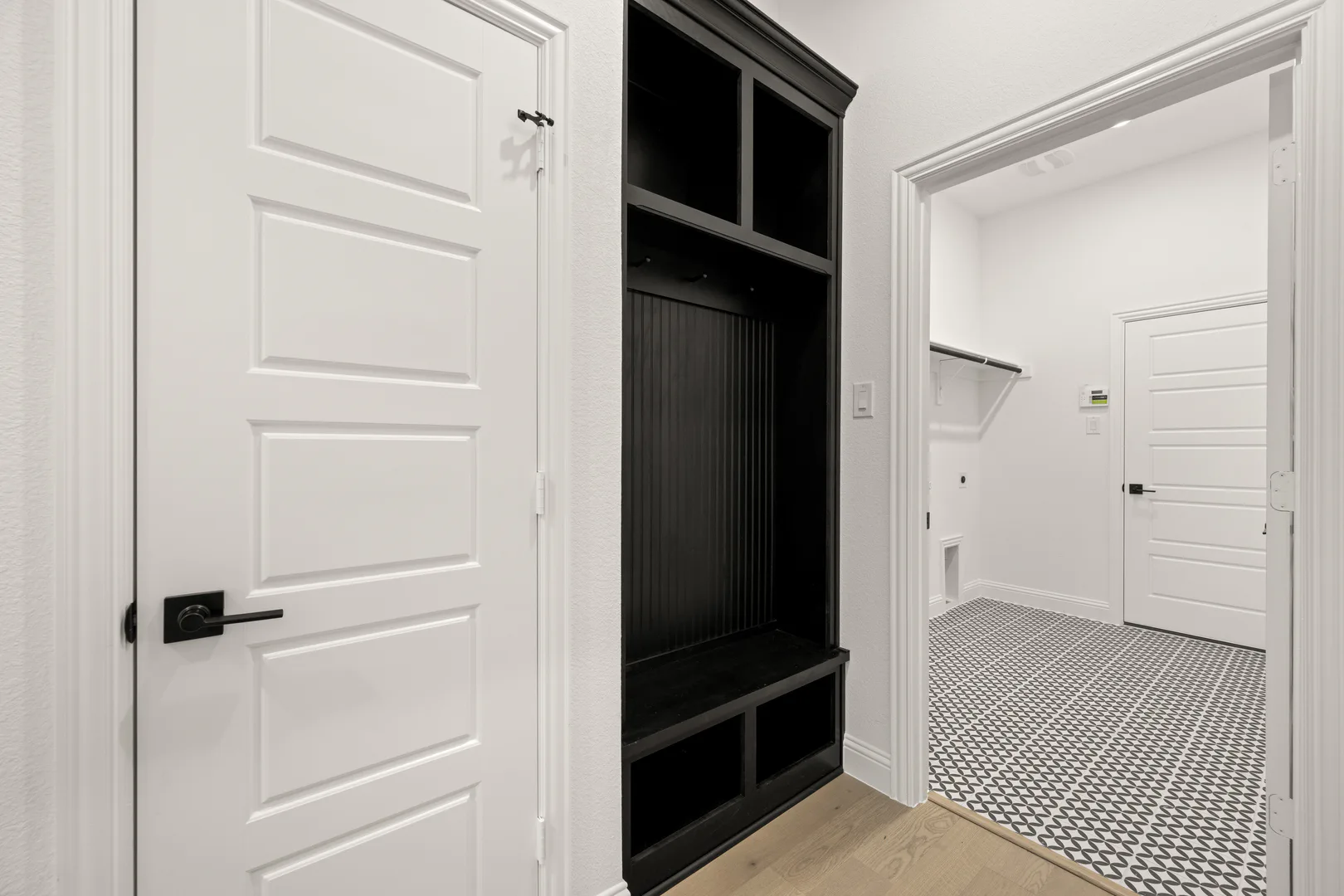 Mud room in a transitional ranch style home by Kindred Homes